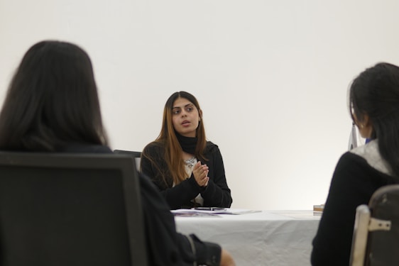 Woman speaking to two people across table