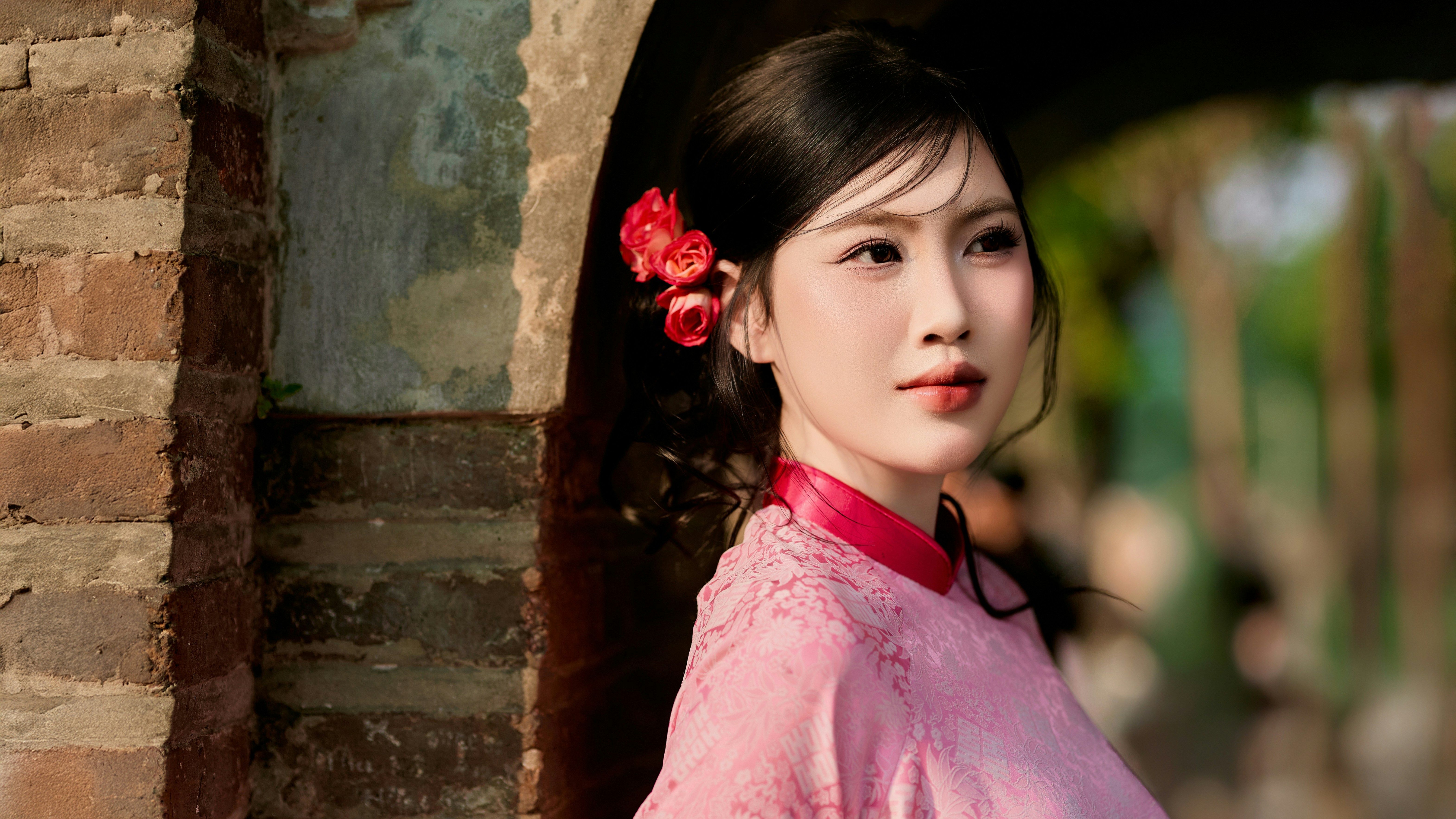 Beautiful Vietnamese girl in traditional Vietnamese dress on Tet holiday by Hoan Kiem Lake