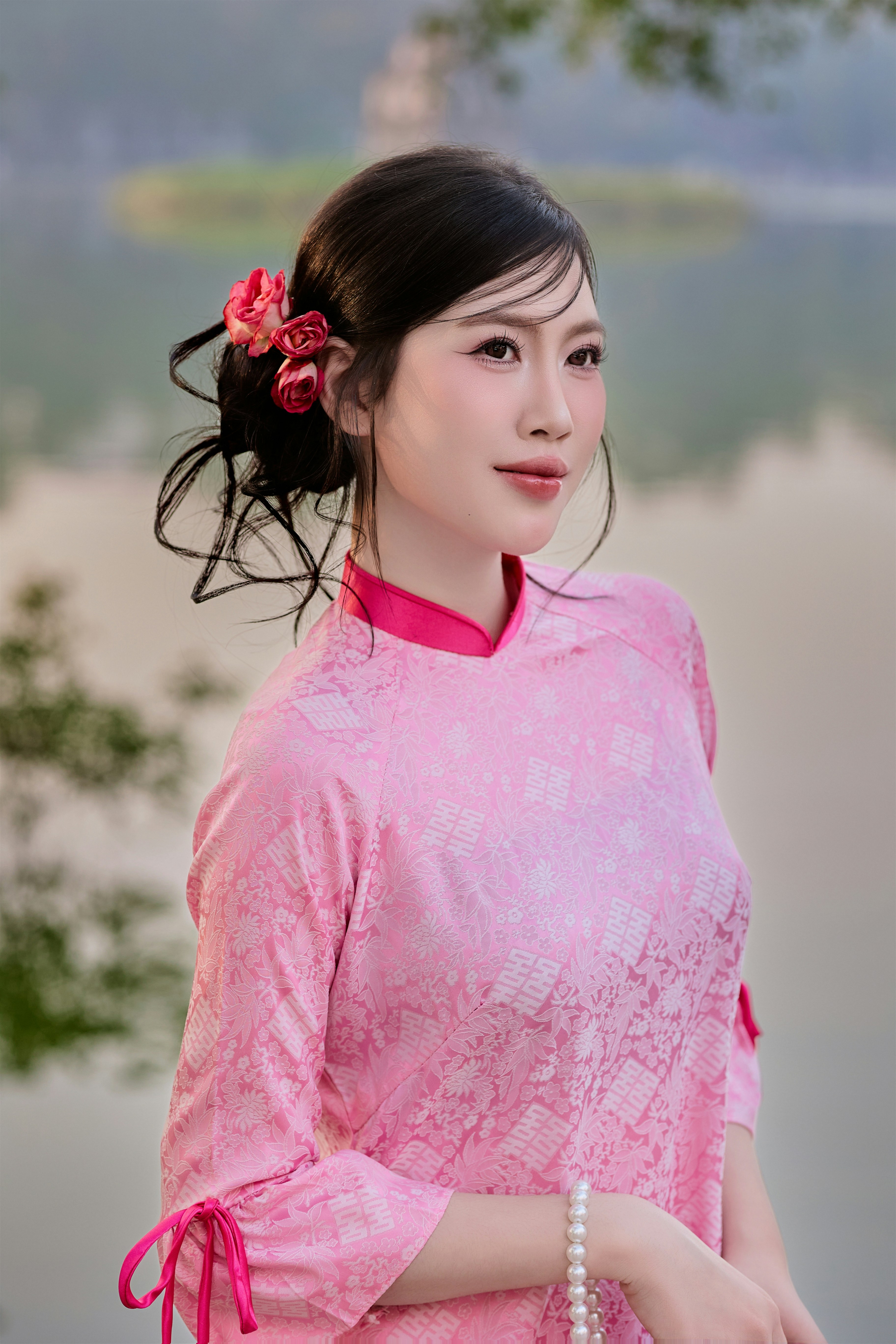 Beautiful Vietnamese girl in traditional Vietnamese dress on Tet holiday by Hoan Kiem Lake