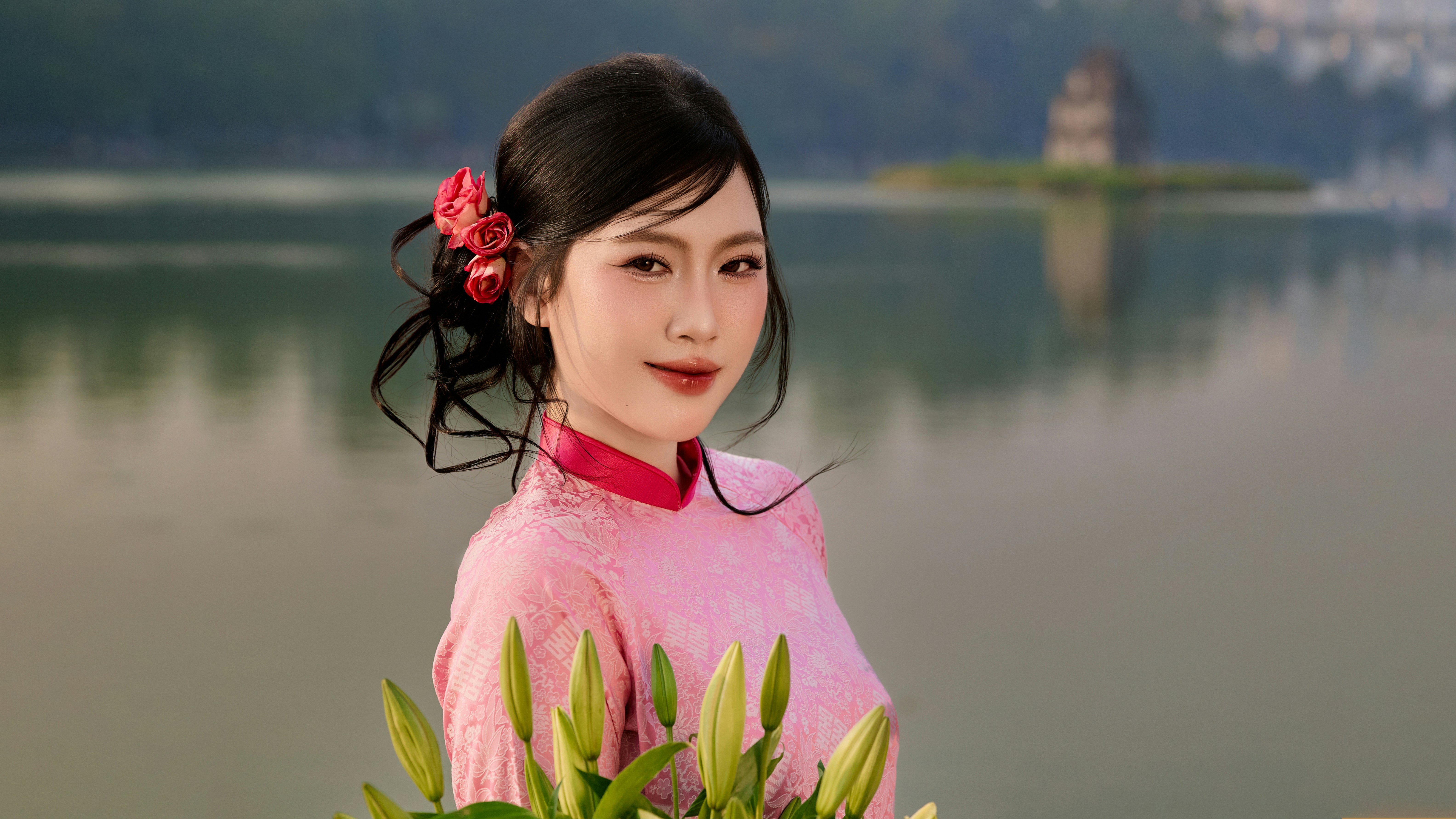 Beautiful Vietnamese girl in traditional Vietnamese dress on Tet holiday by Hoan Kiem Lake
