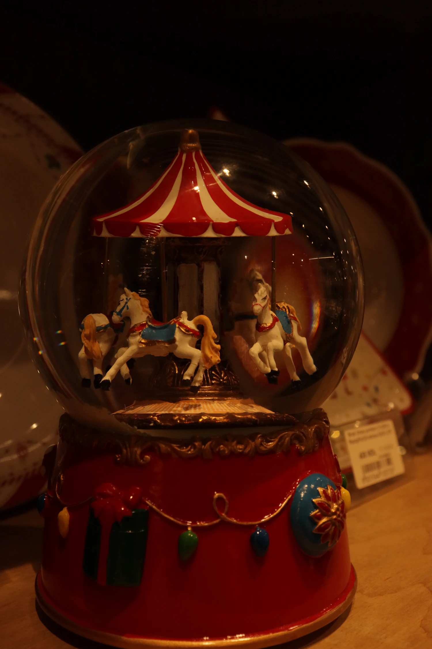 Fairground Globe: a striped carousel inside a glass dome on a red painted base