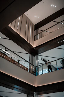 Modern interior architecture with escalators and railings.