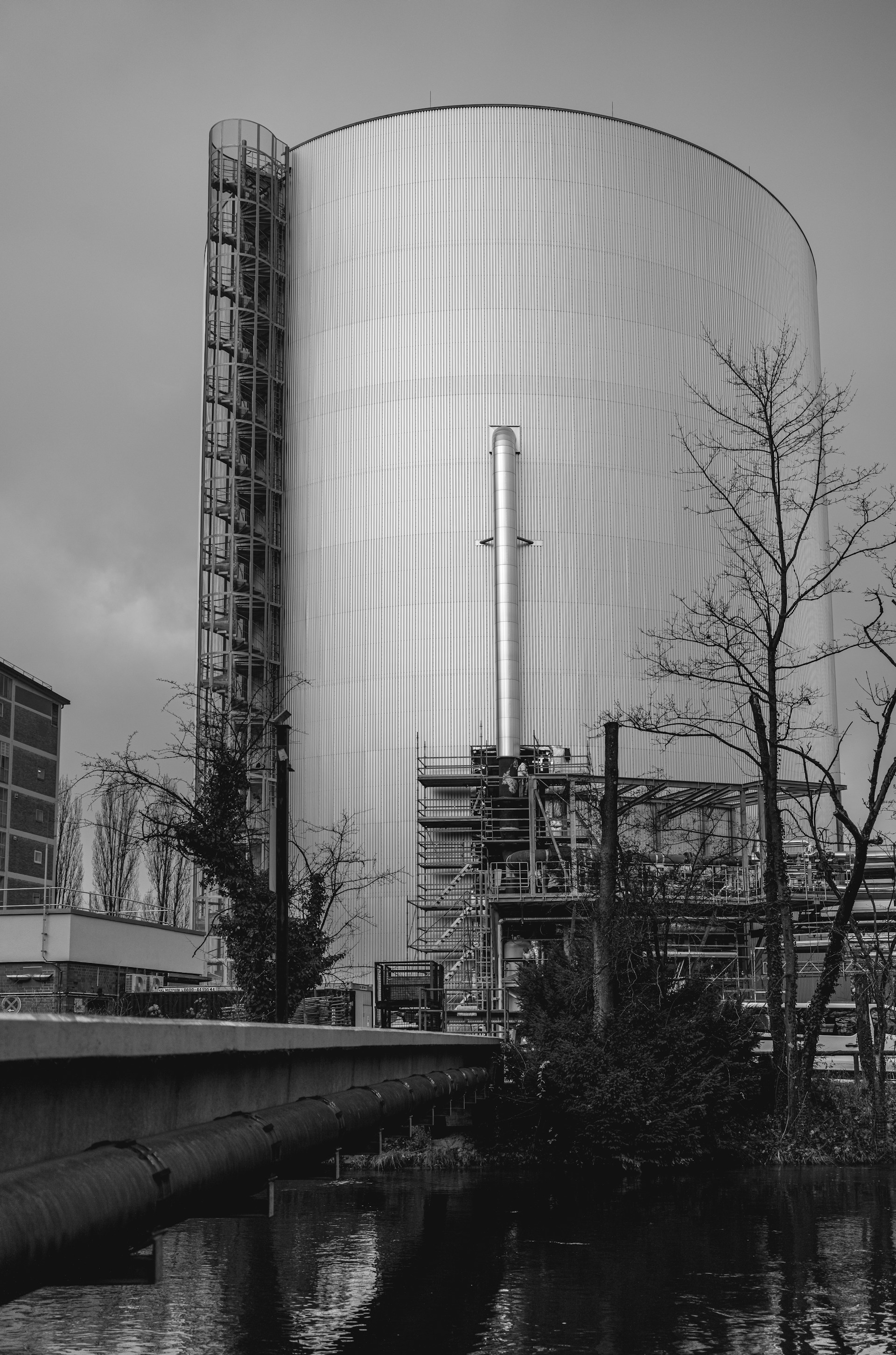Industrial silo structure with pipes and trees