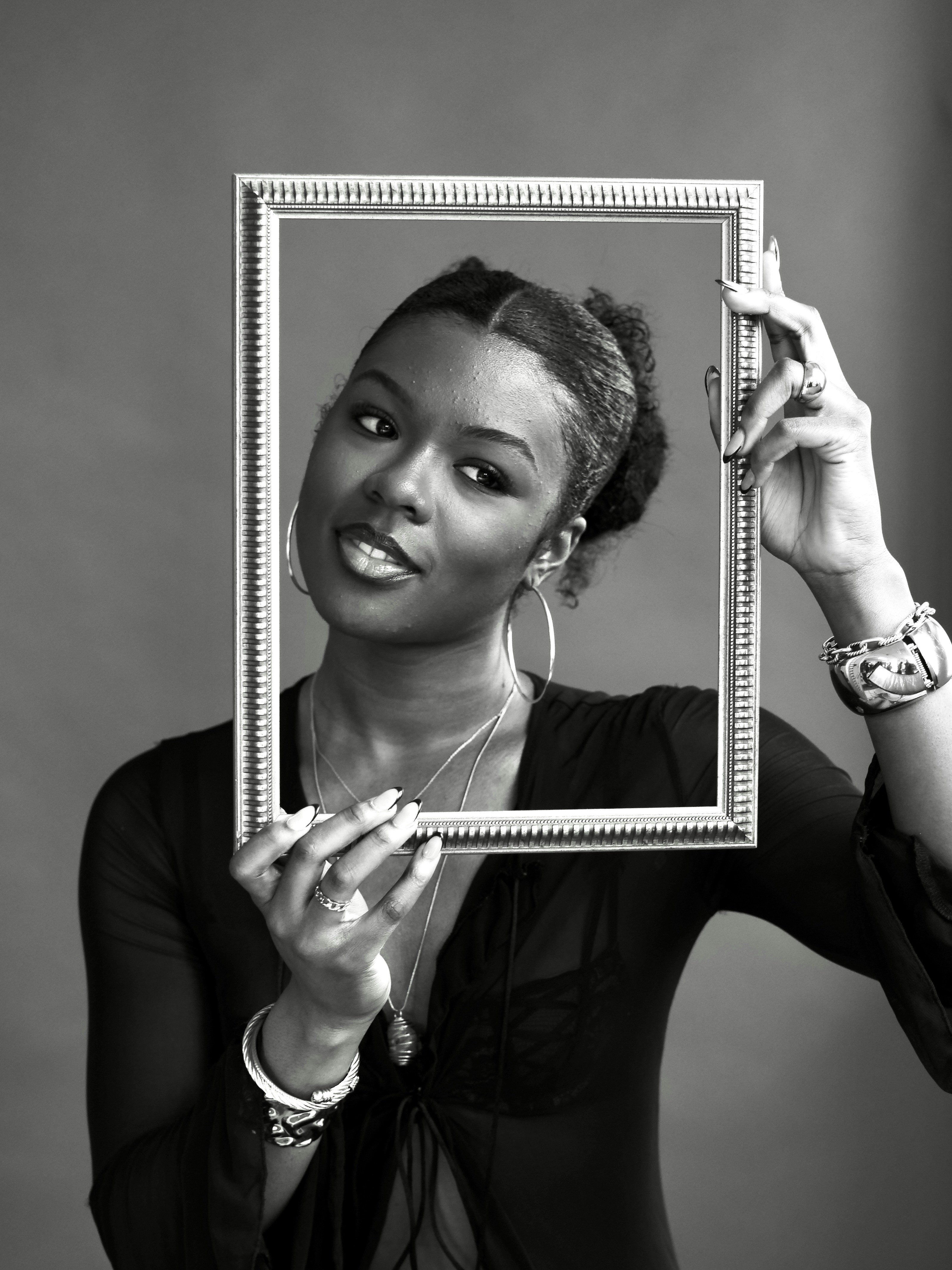 Woman holding a picture frame in front of her face