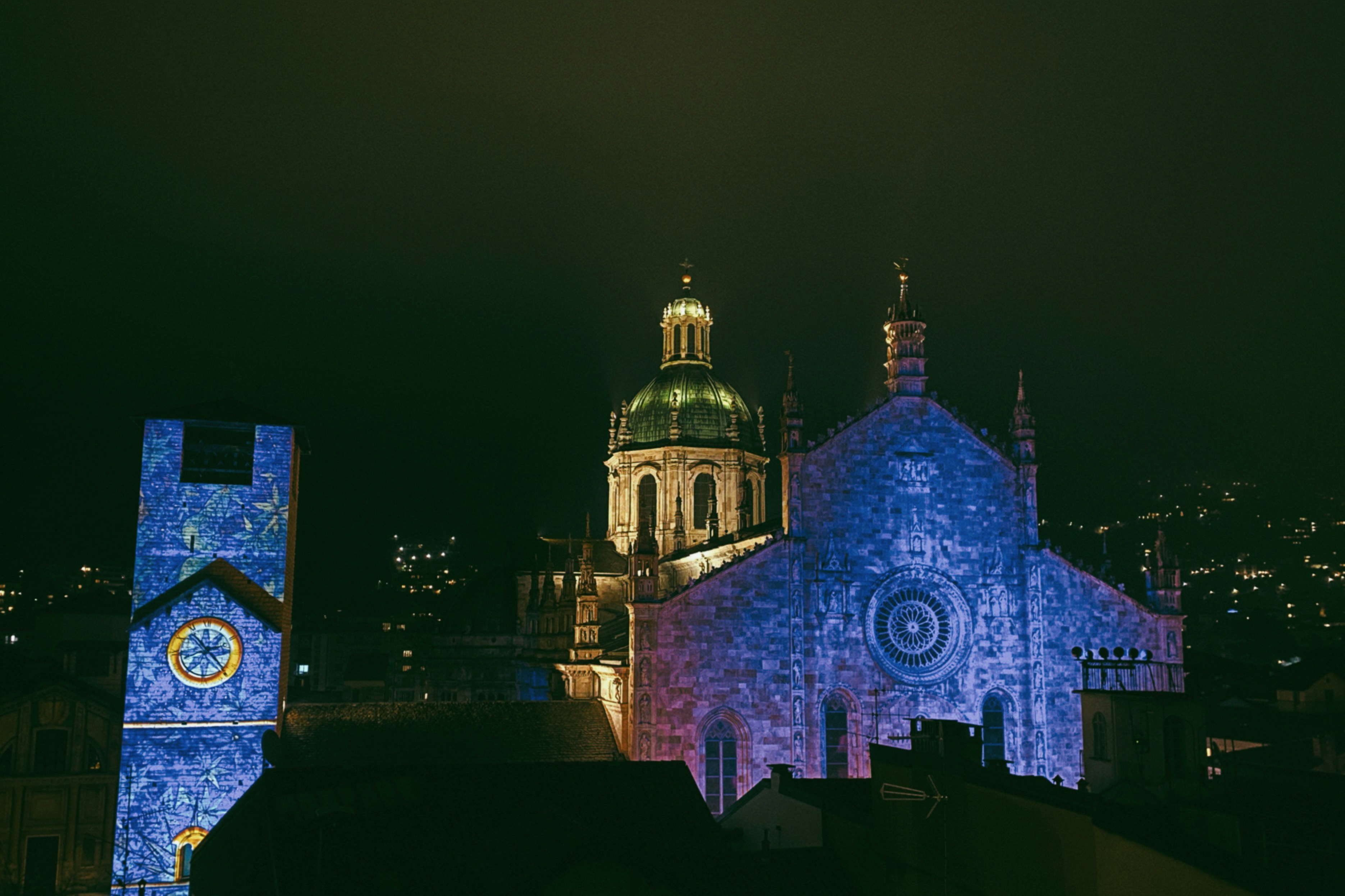 Ornate buildings illuminated with blue light at night