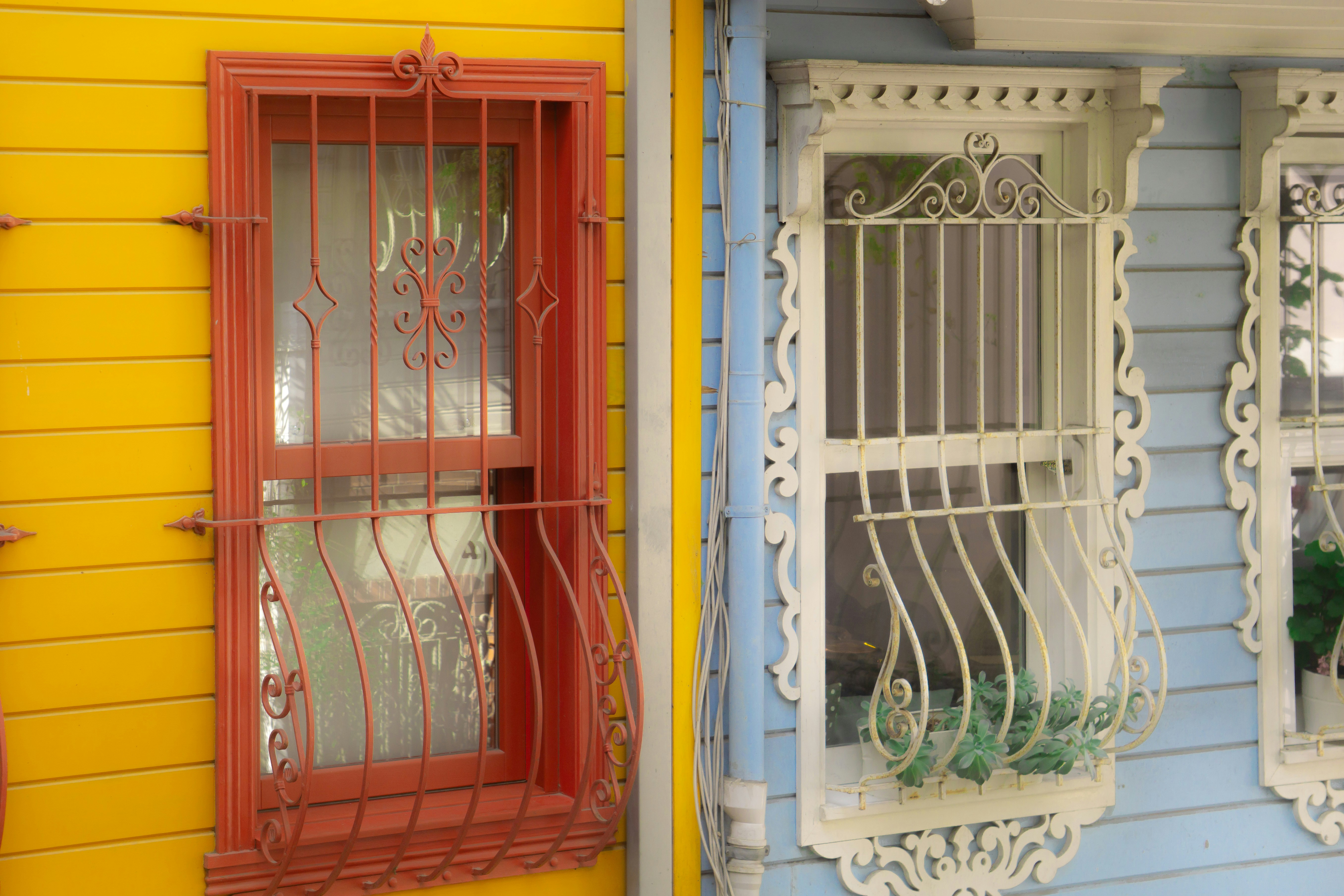 Two colorful houses with ornate windows