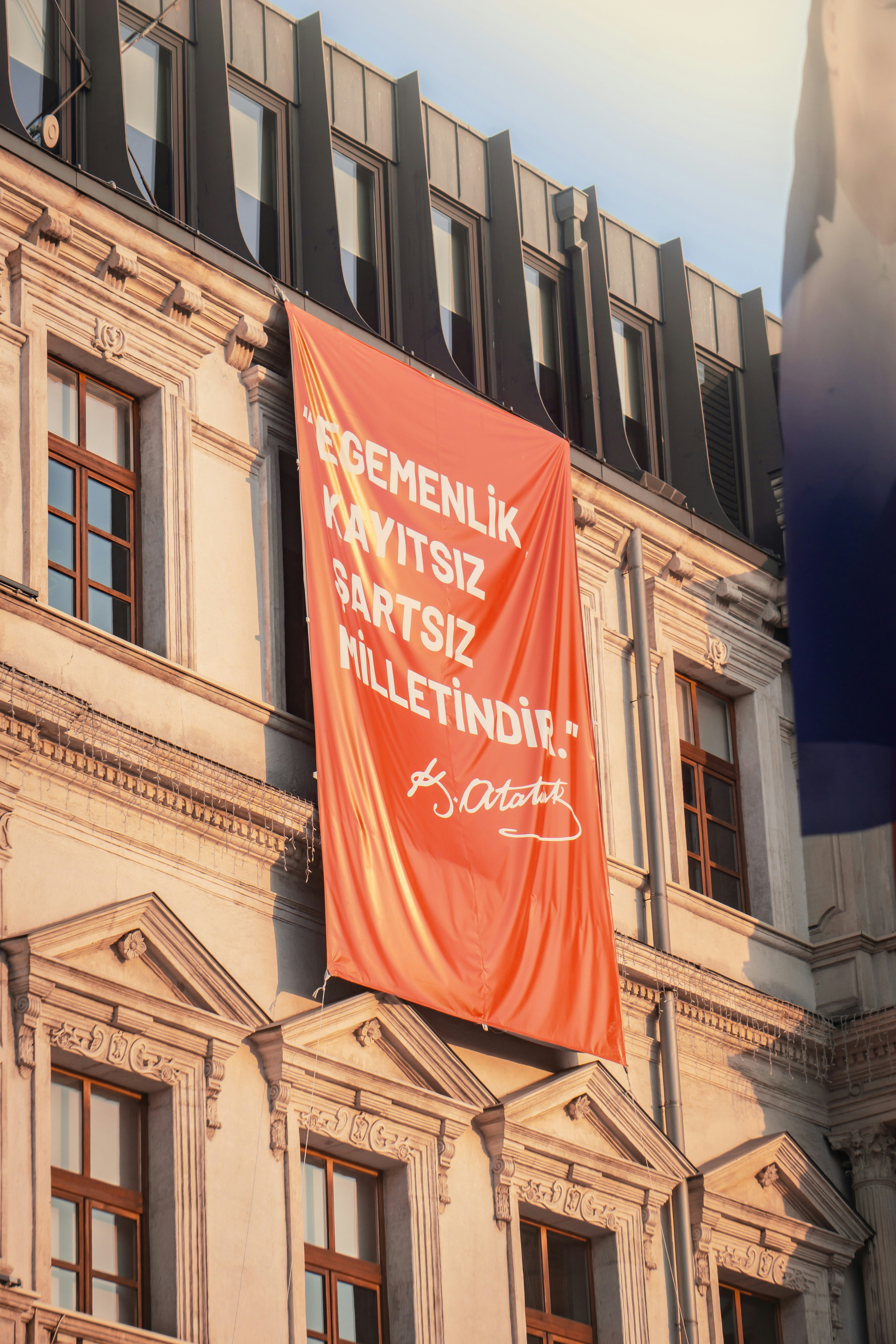 Red banner with turkish text on building facade
