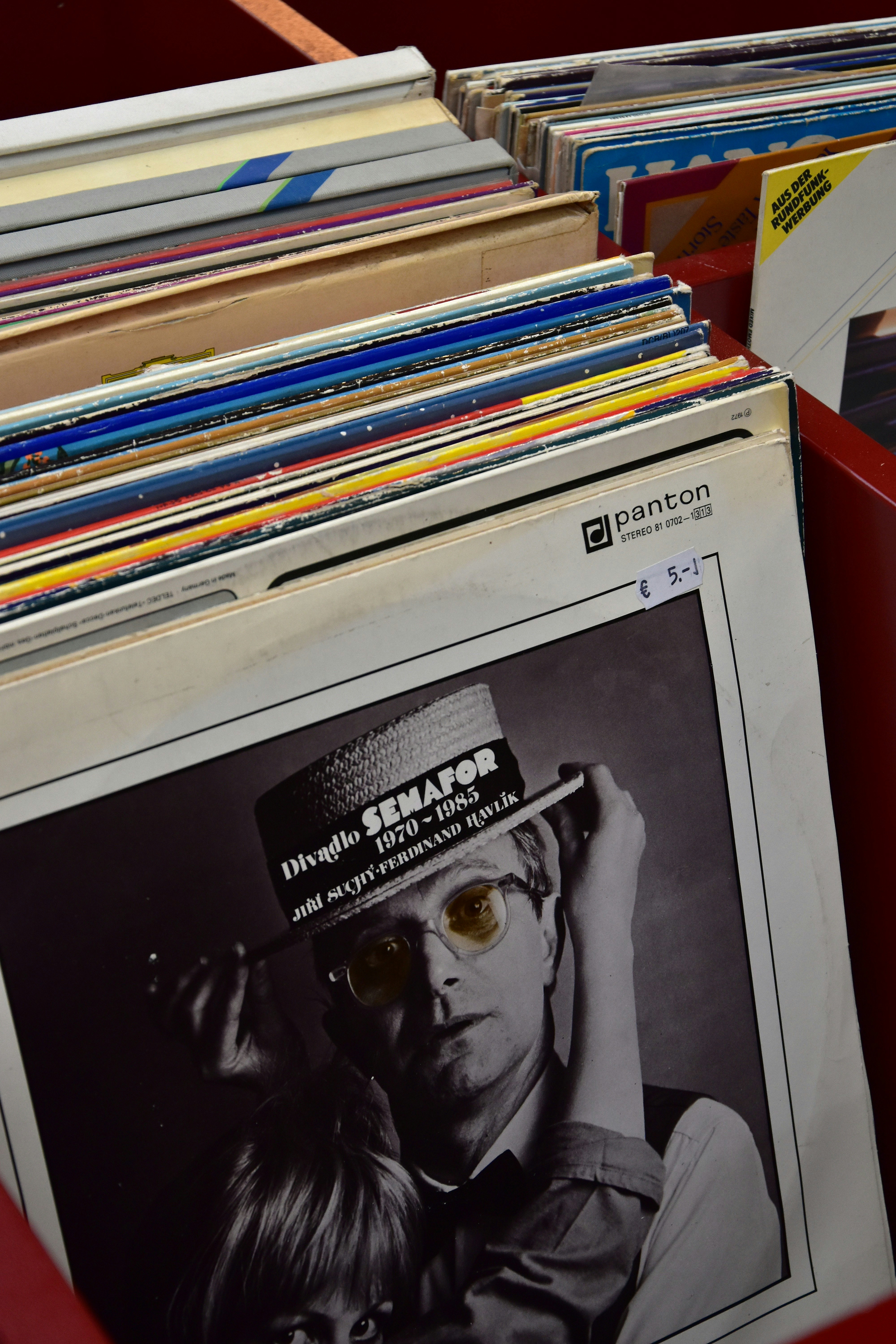Stack of vintage vinyl records in a crate.
