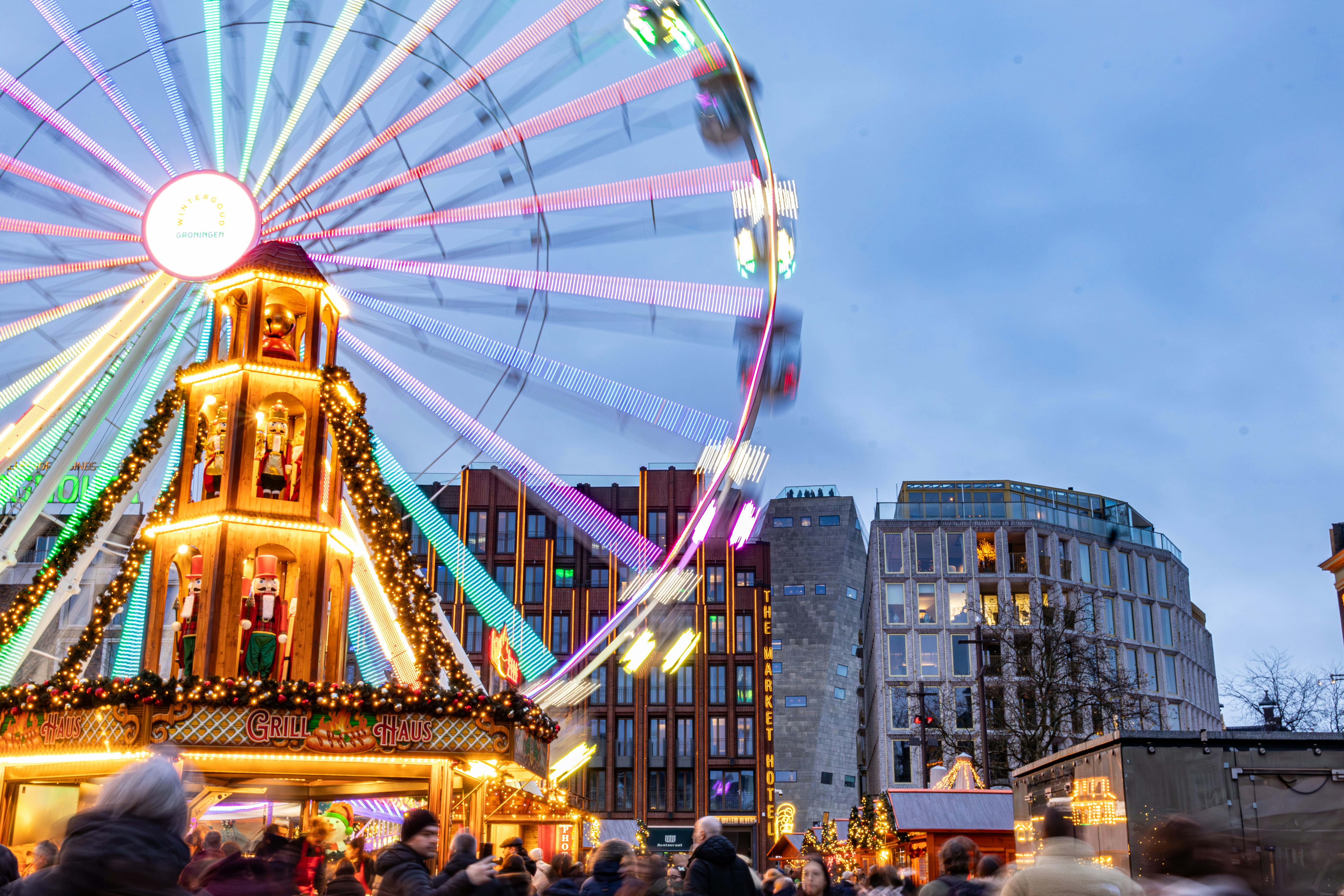 Bright ferris wheel at a festive night market.