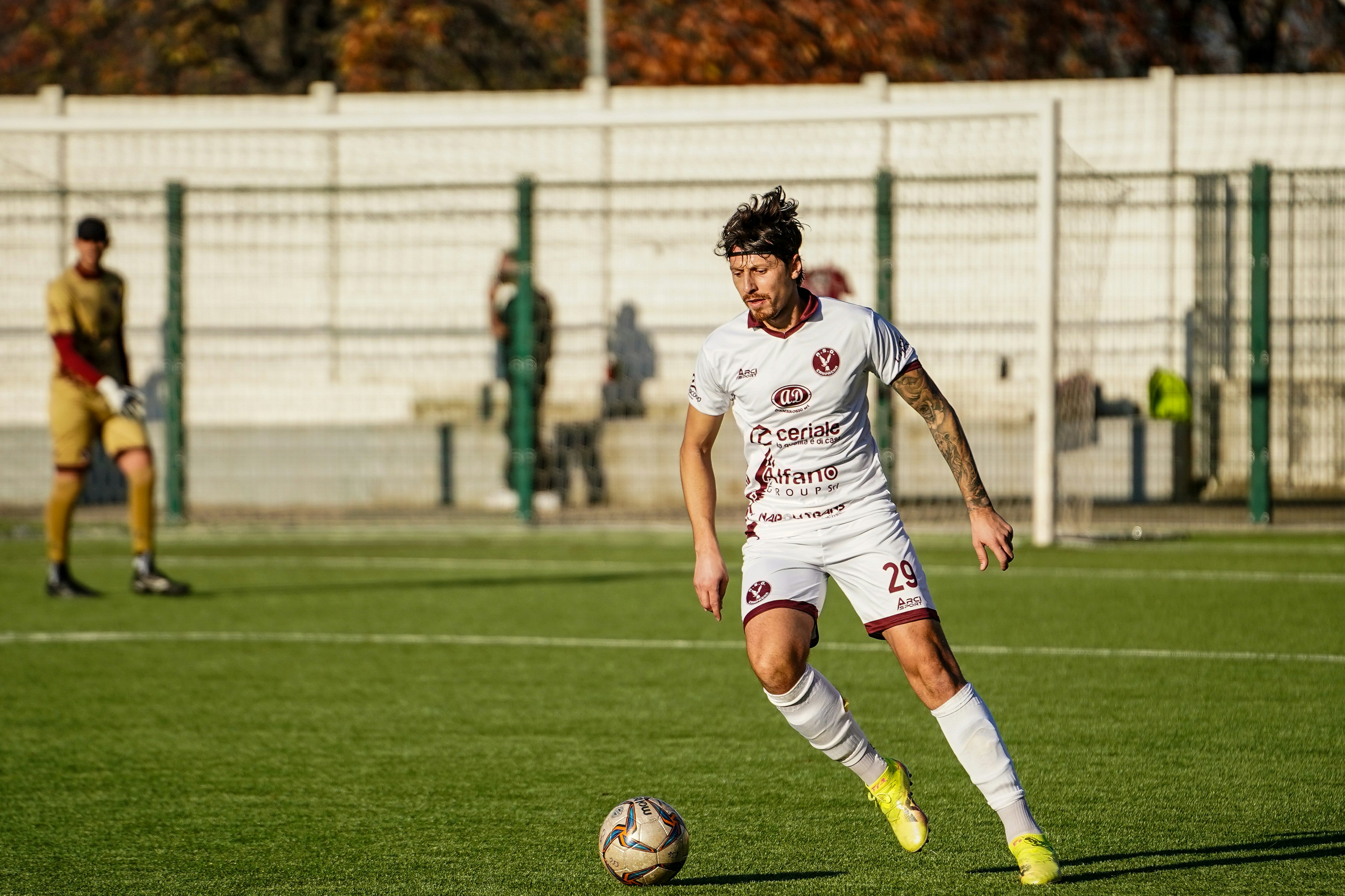 Soccer player dribbling ball on field