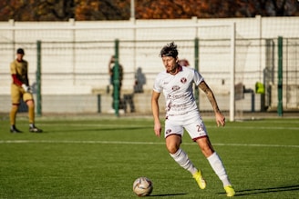 Soccer player dribbling ball on field