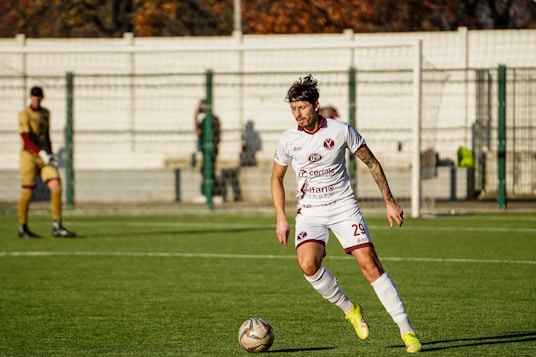 Soccer player dribbling ball on field
