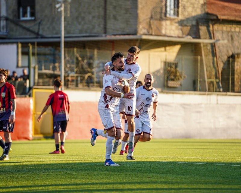 professional soccer players celebrating match victory