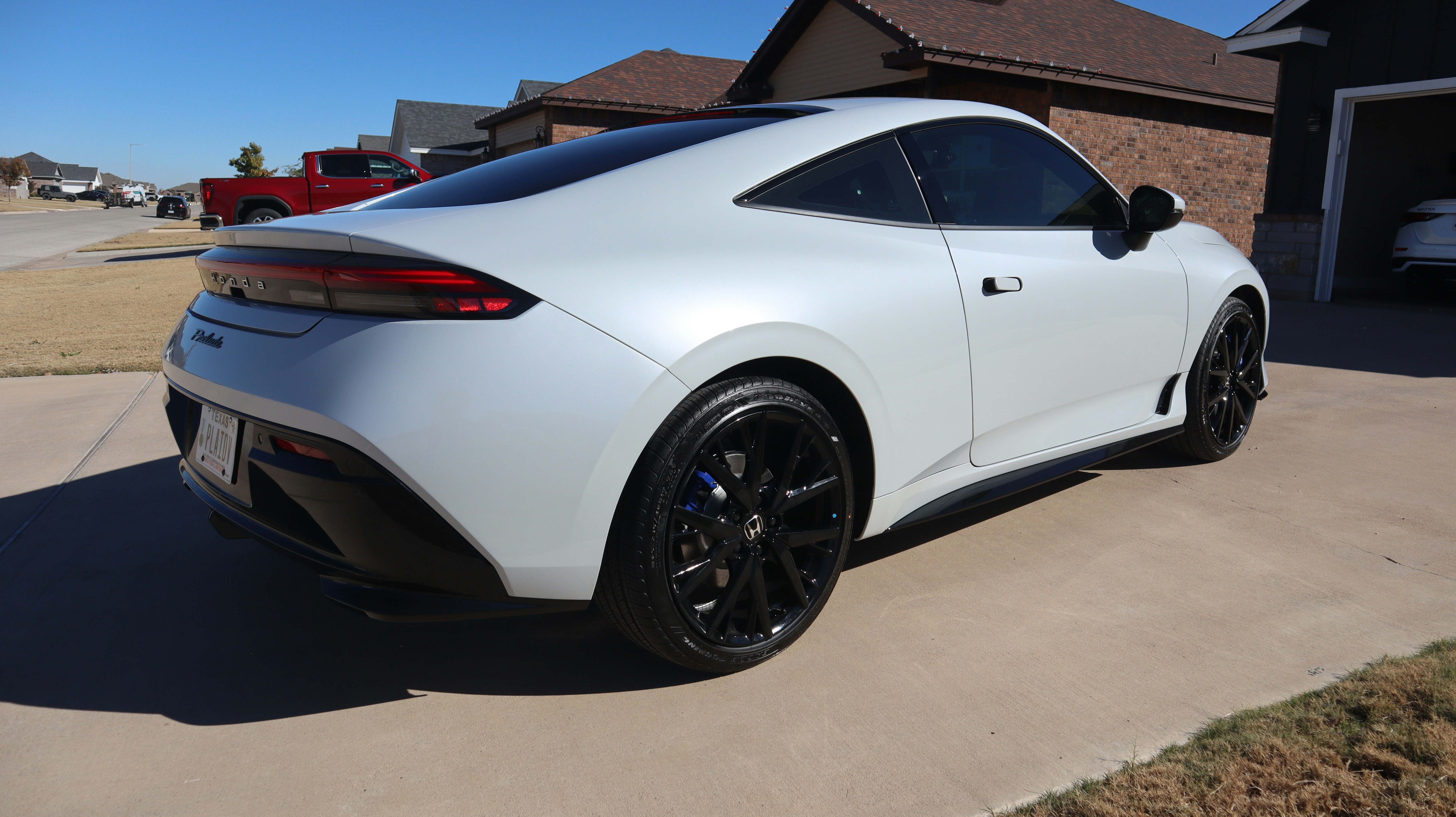 White sports car parked on a driveway