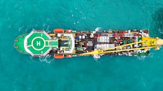 Aerial view of a large industrial ship with a helipad.