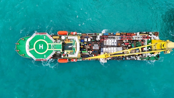Aerial view of a large industrial ship with a helipad.