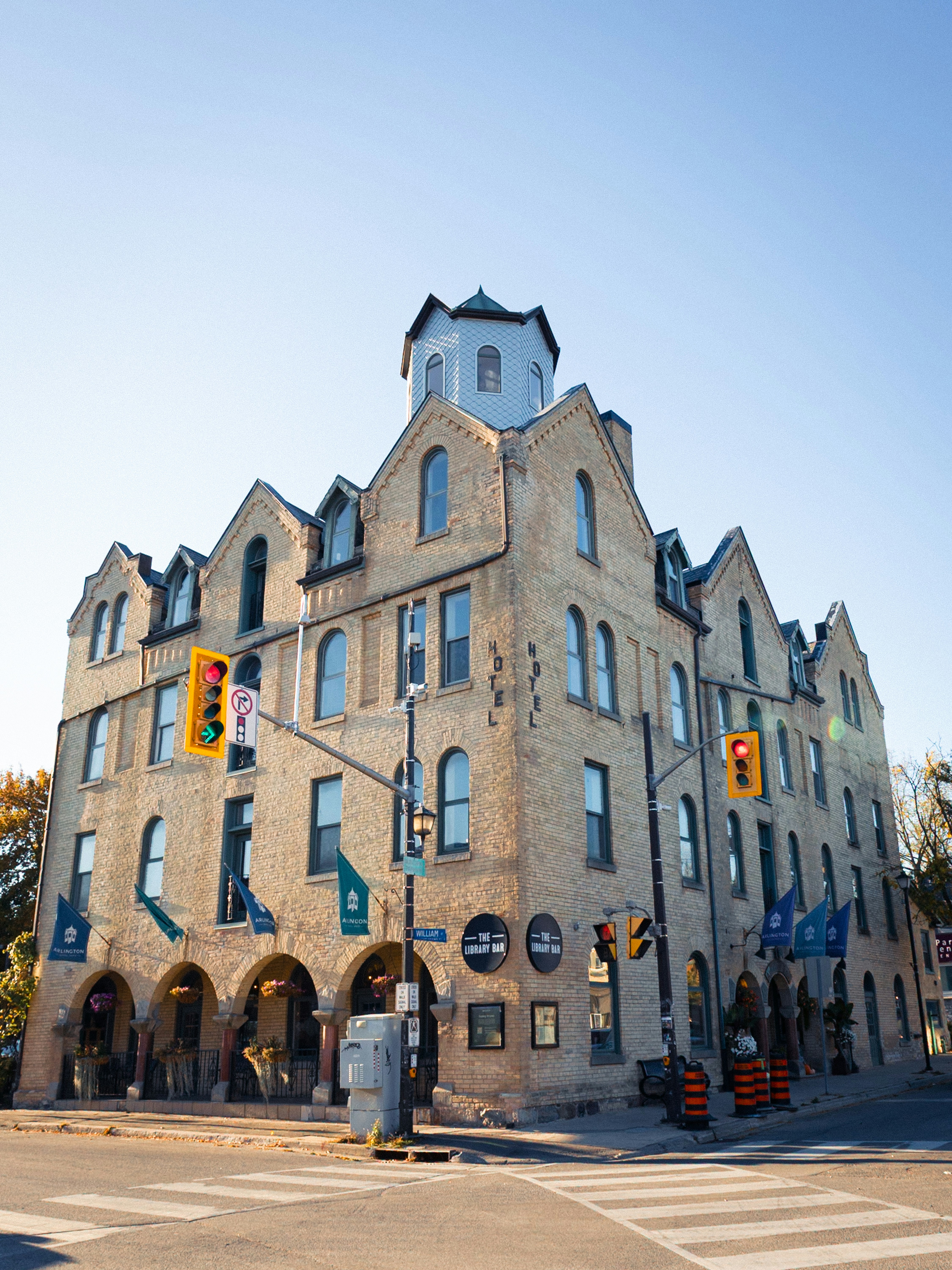Historic brick building with arched storefronts and tower