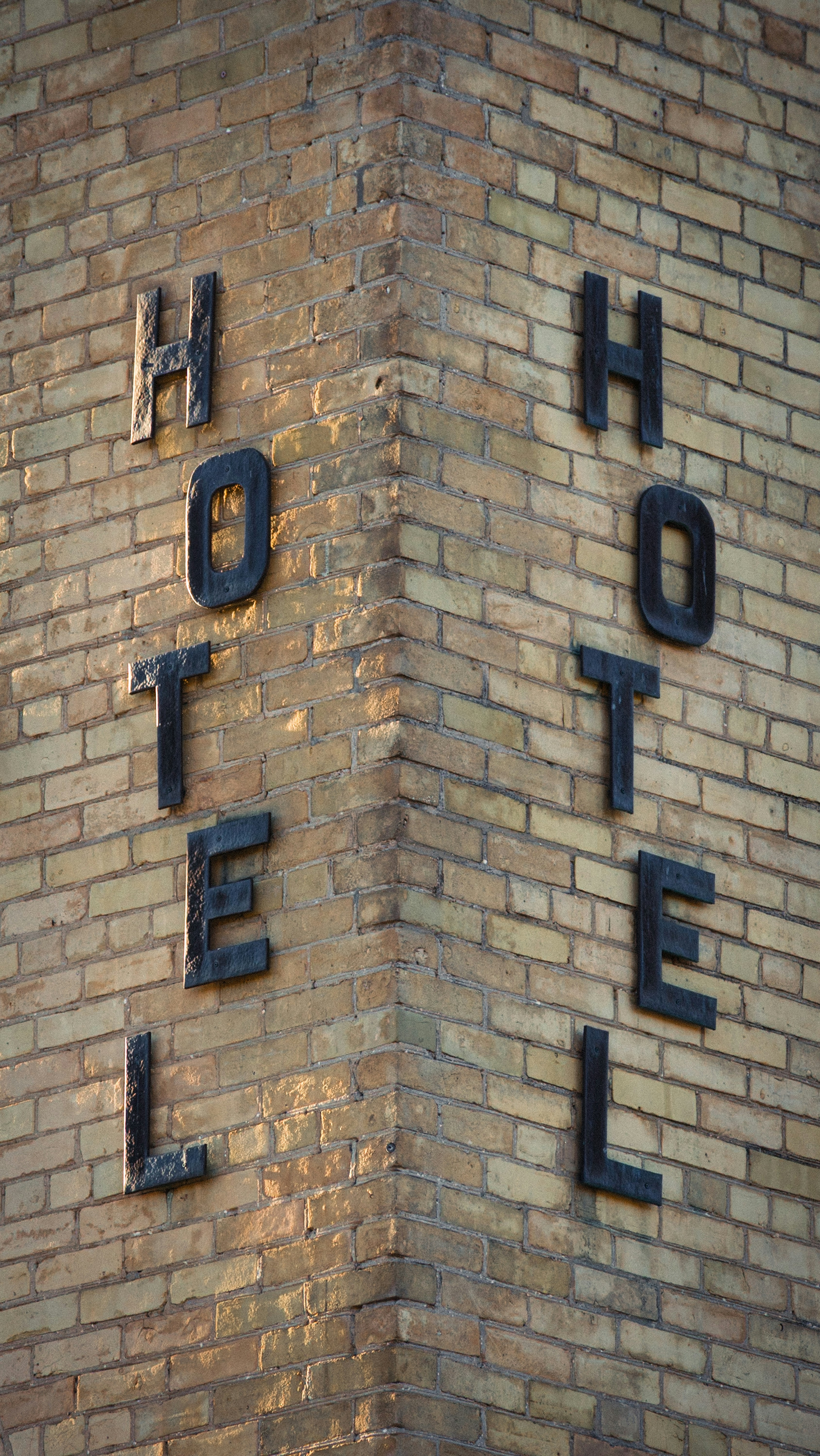 Hotel sign on a brick building corner building corner
