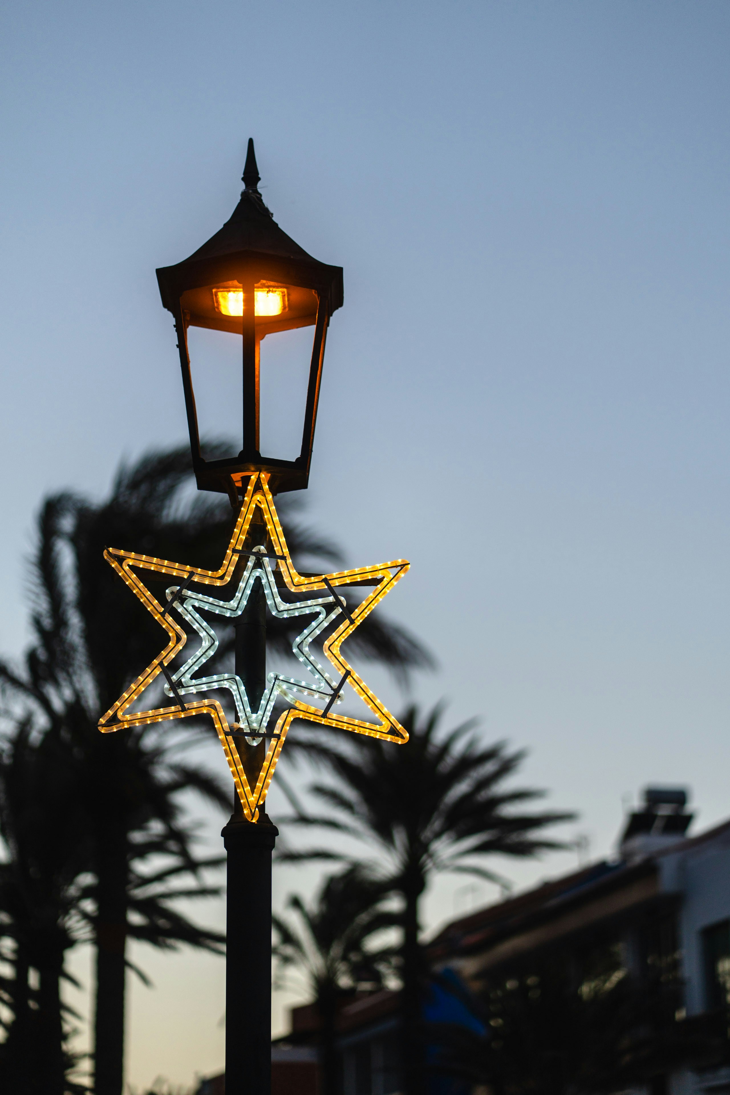 Street lamp with star decoration at dusk