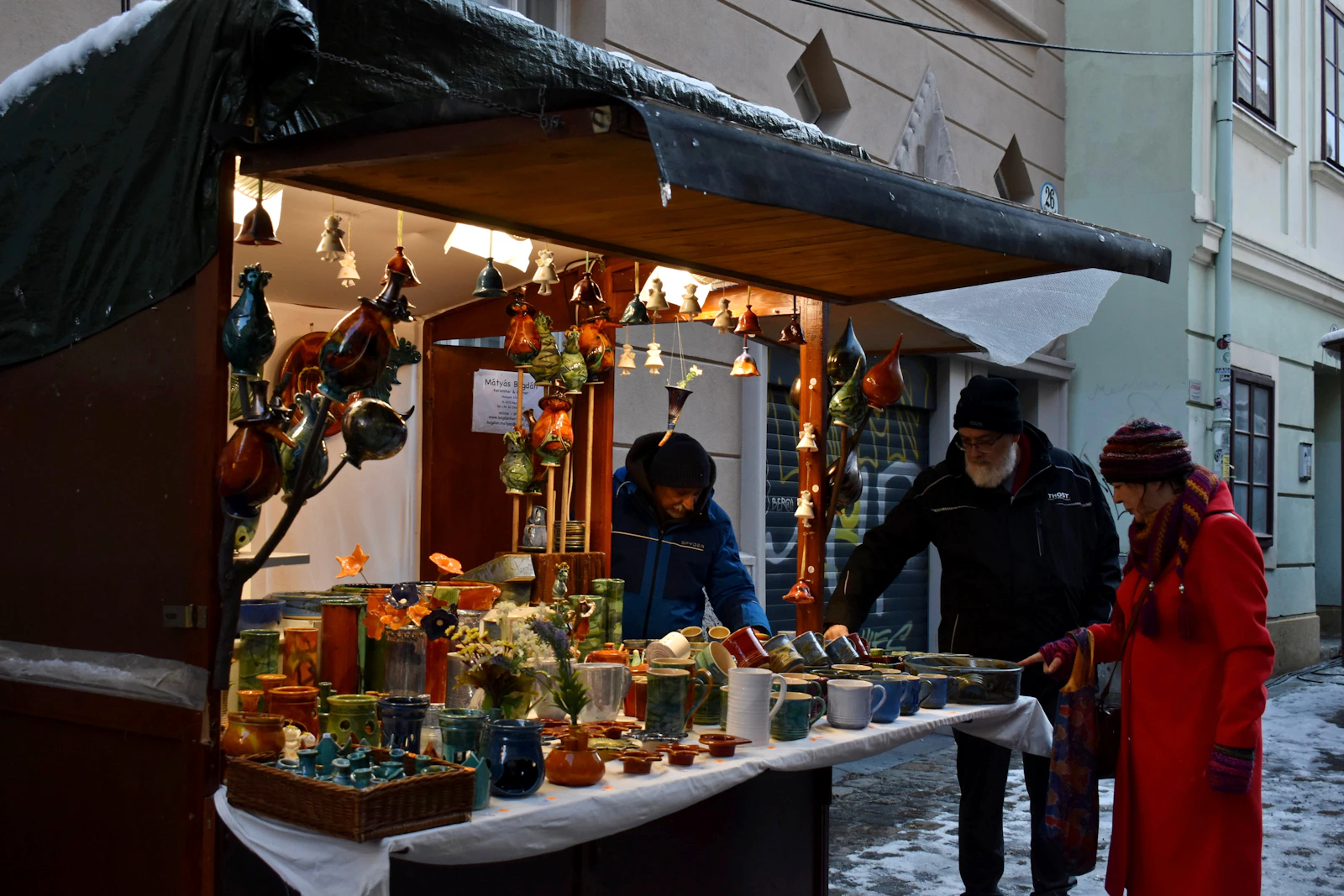 Visitors looking at crafts on a Spittelberg Christmas market stall