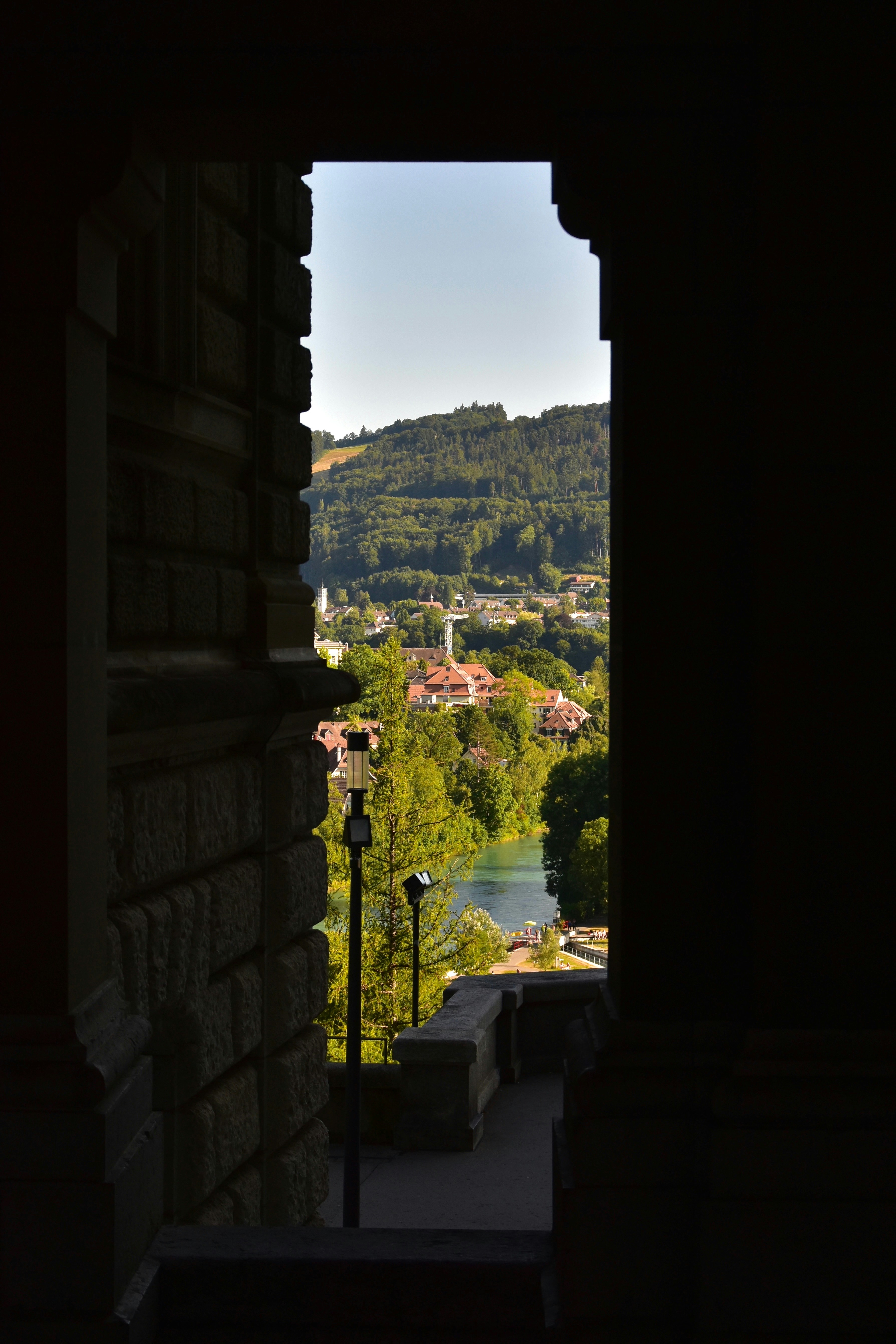 View of a european town through a stone archway.