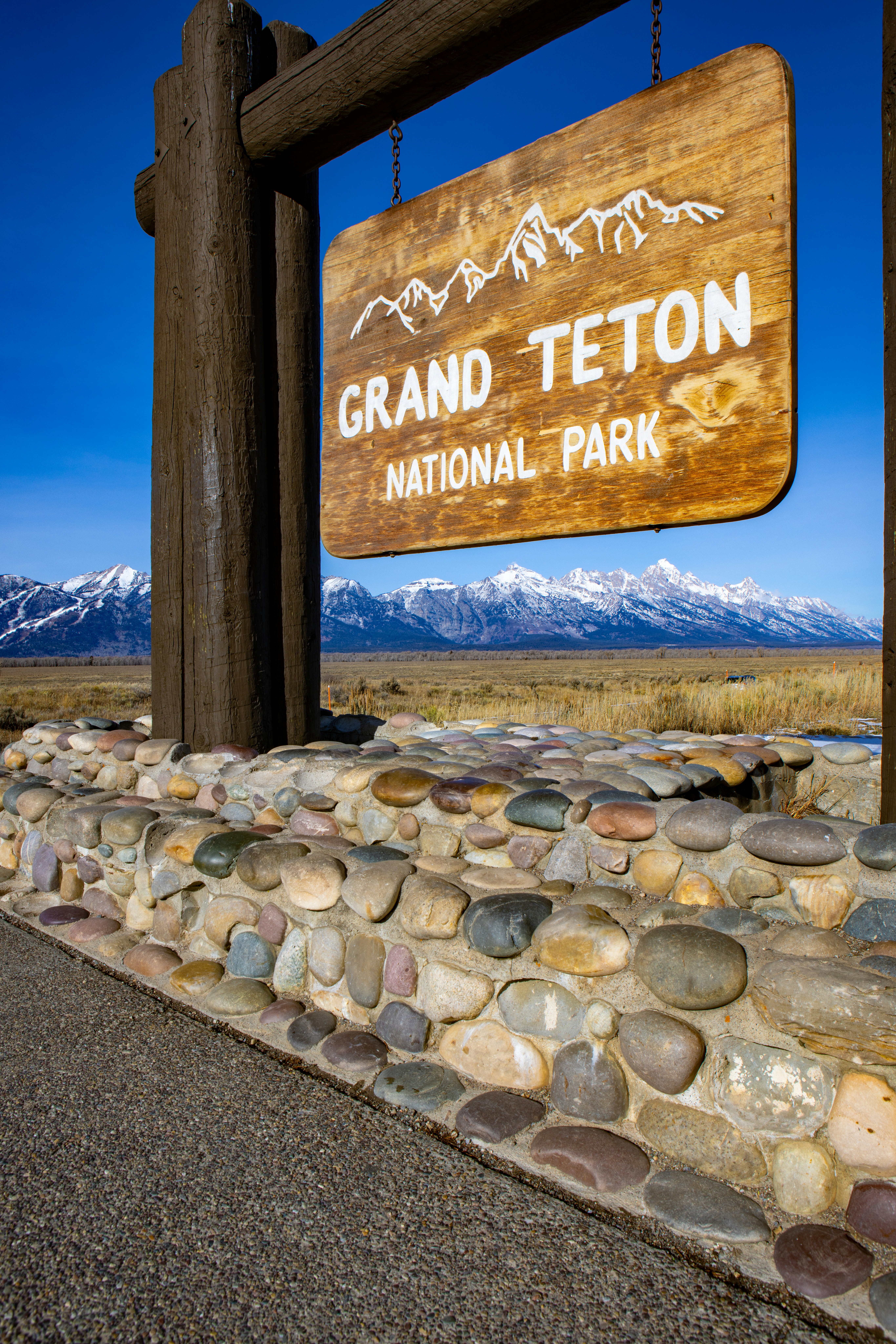 Grand Teton National Park sign with the Tetons in the background on Tuesday, November 25, 2025.