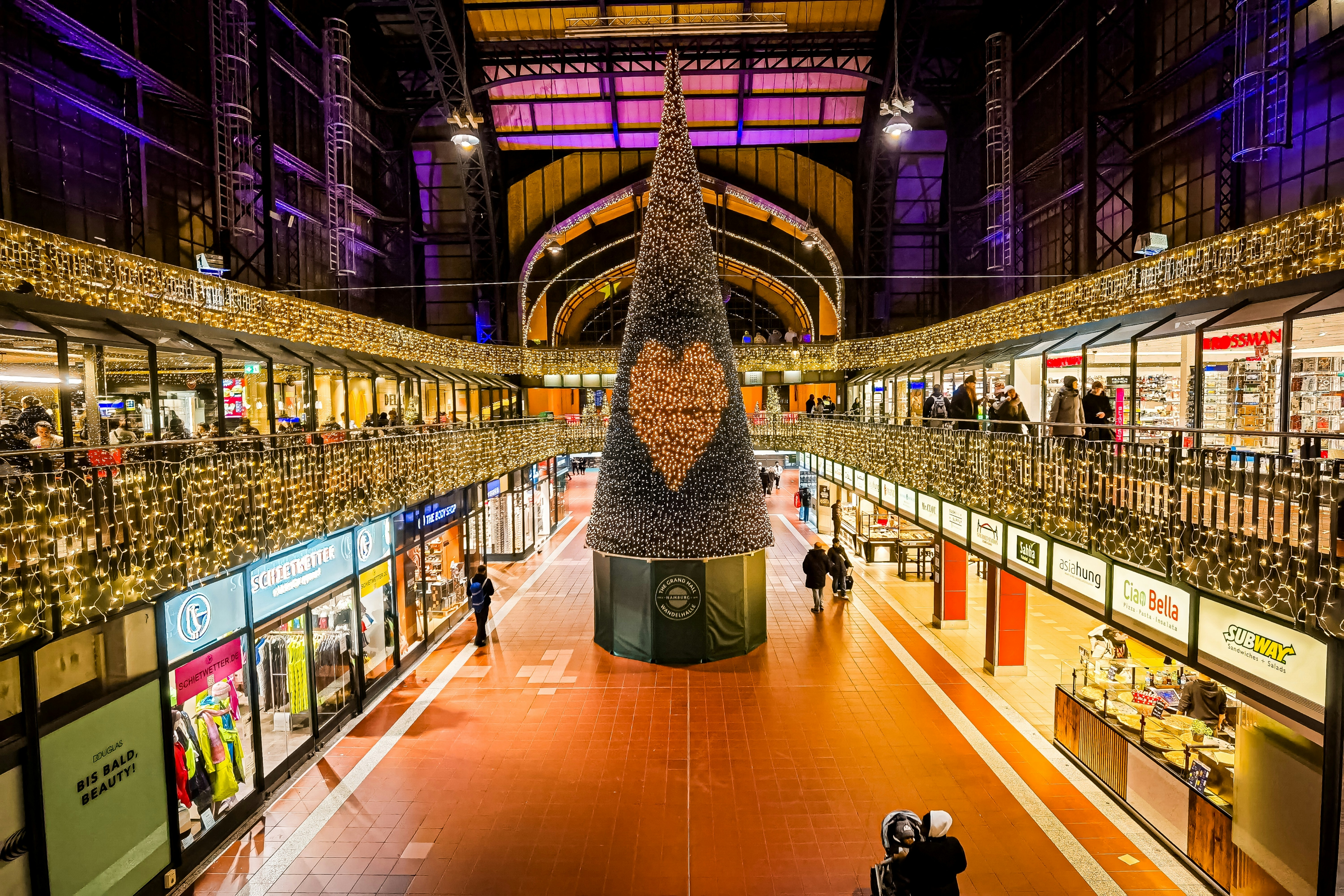 Shopping centre concourse with a large Christmas tree