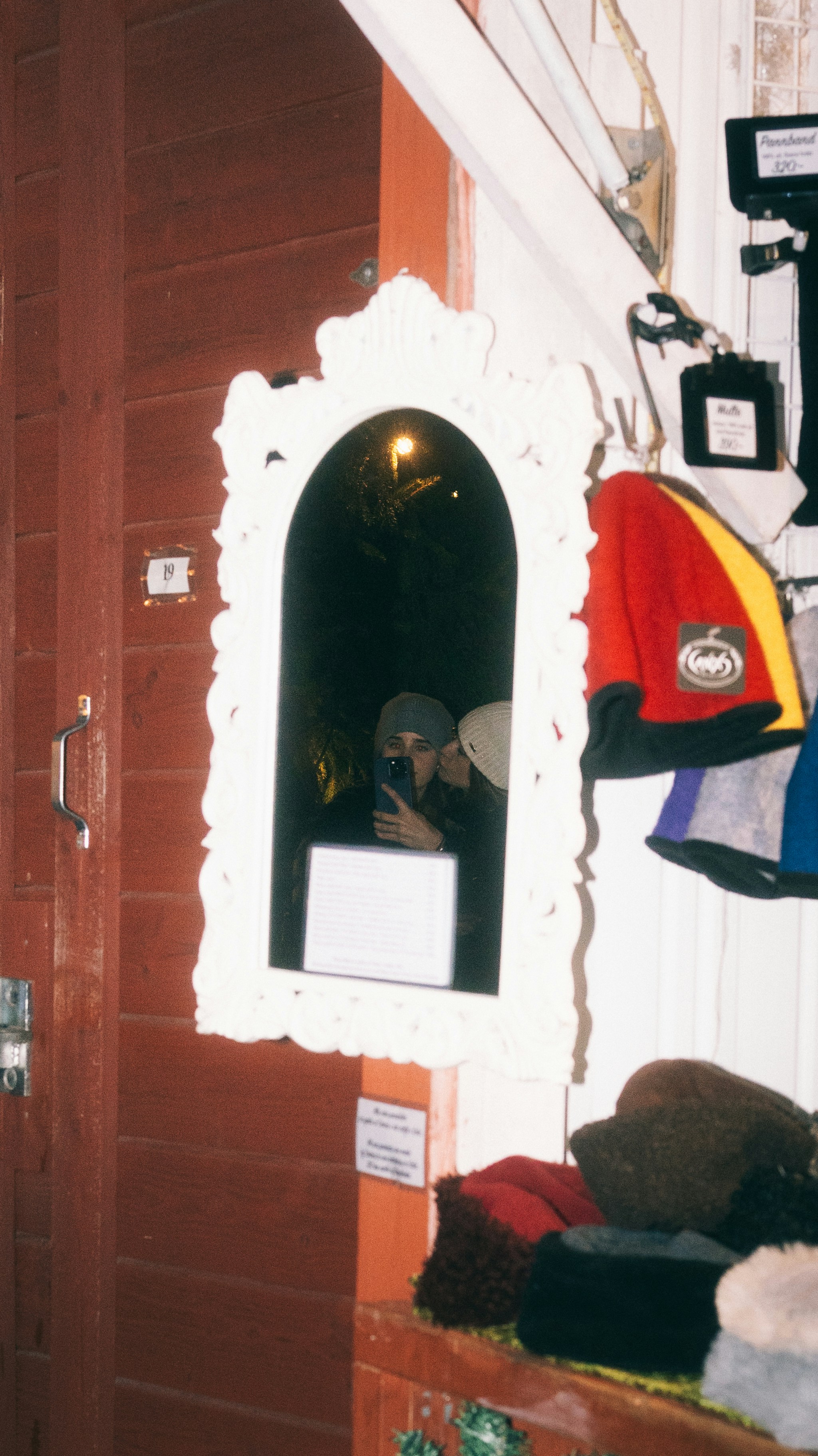 Reflection in ornate mirror of person taking selfie