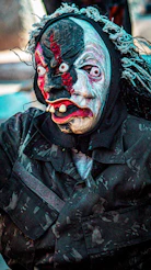 Person in a creepy mask and camouflage uniform