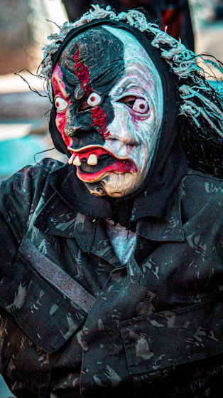 Person in a creepy mask and camouflage uniform