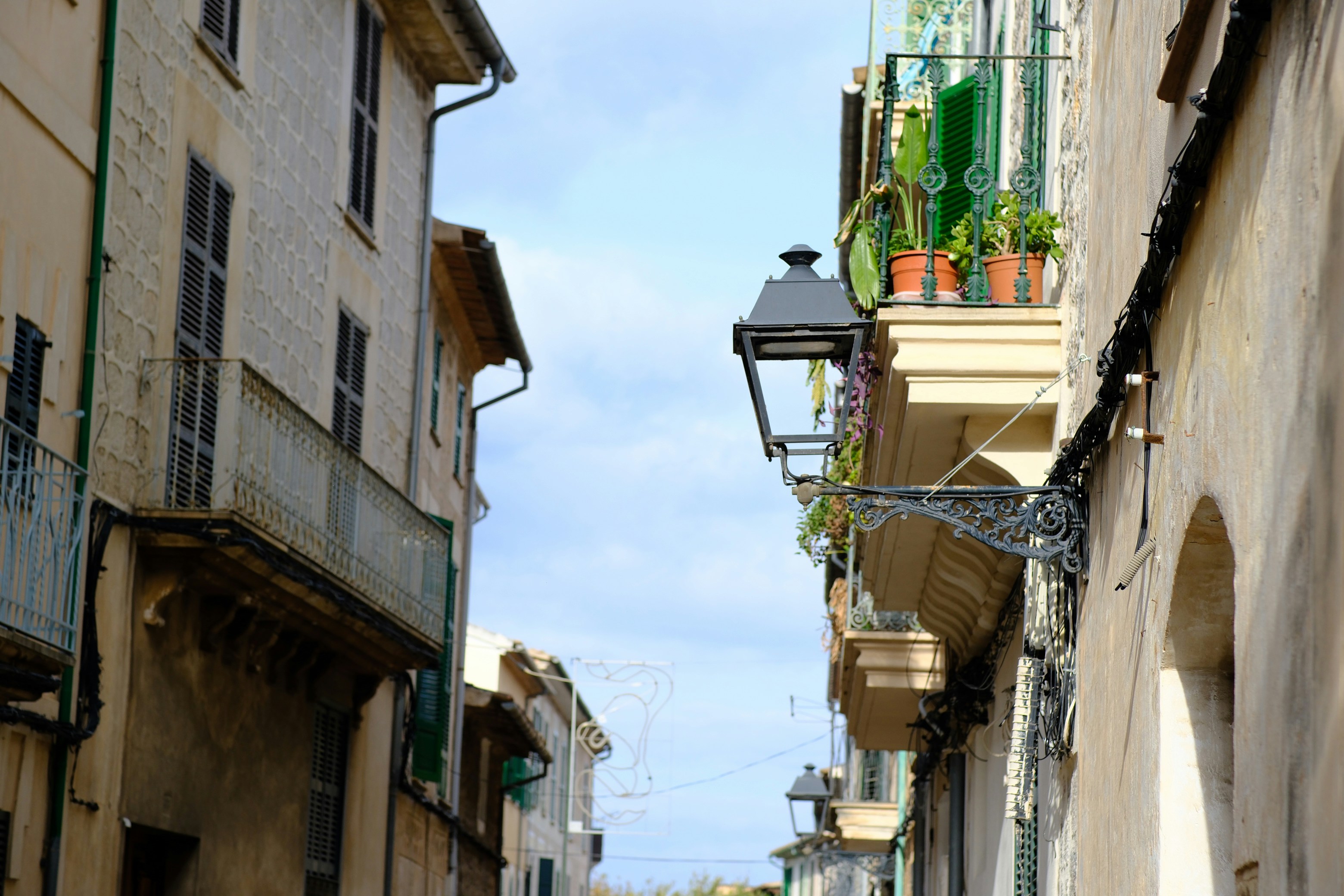 Narrow european street with balconies and buildings