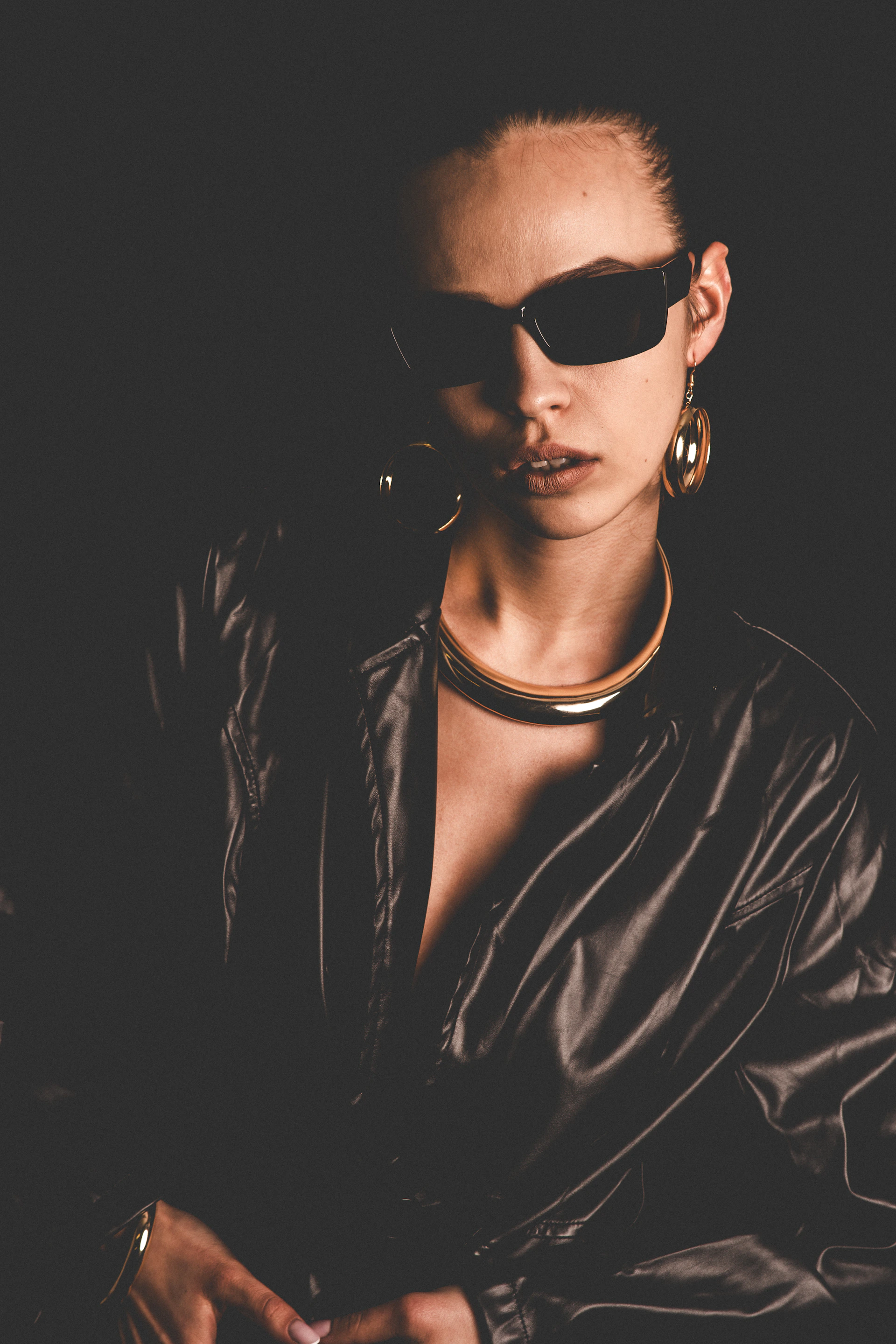 Woman wearing sunglasses and large hoop earrings