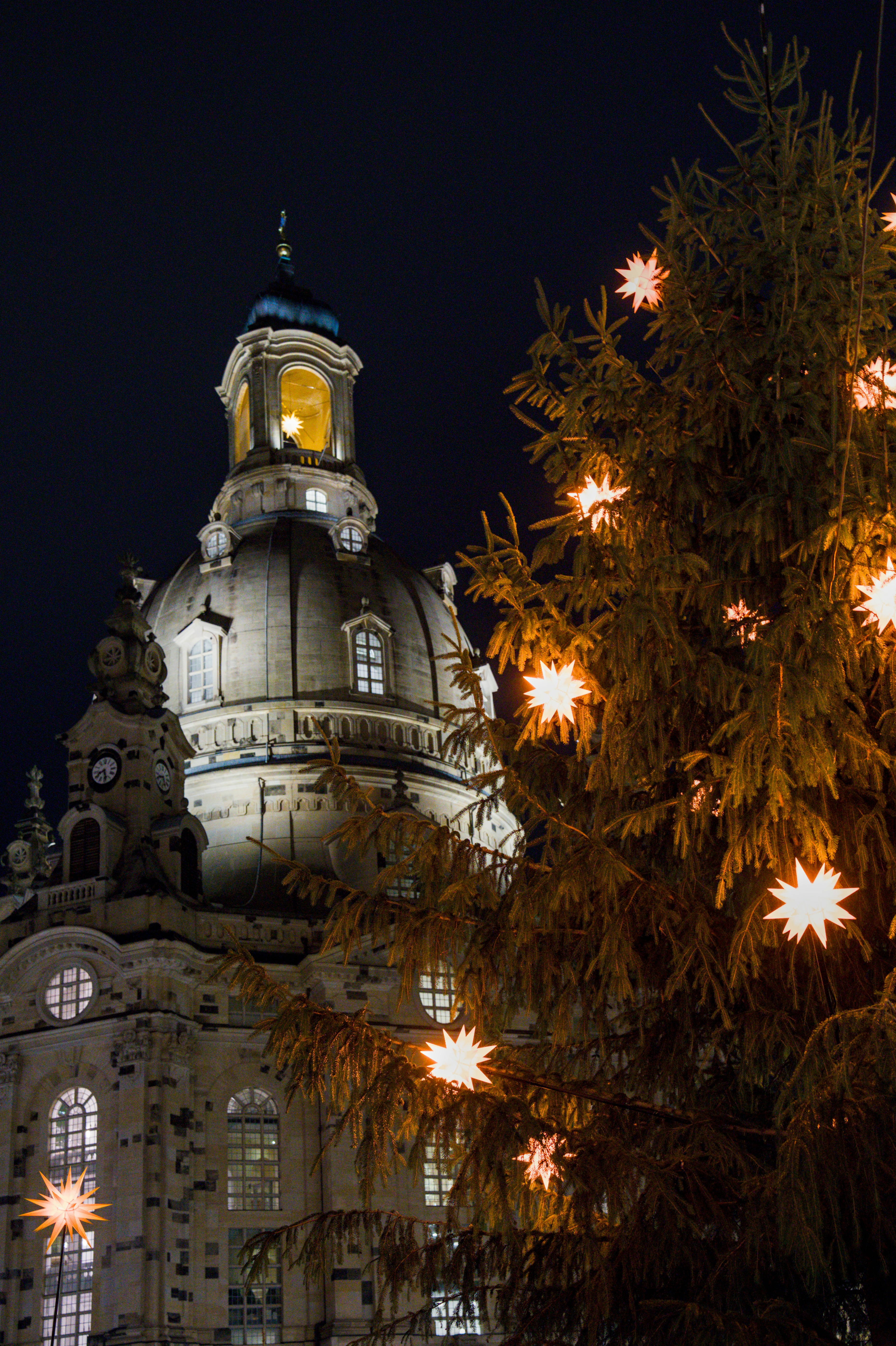 Christmas tree with lights in front of church