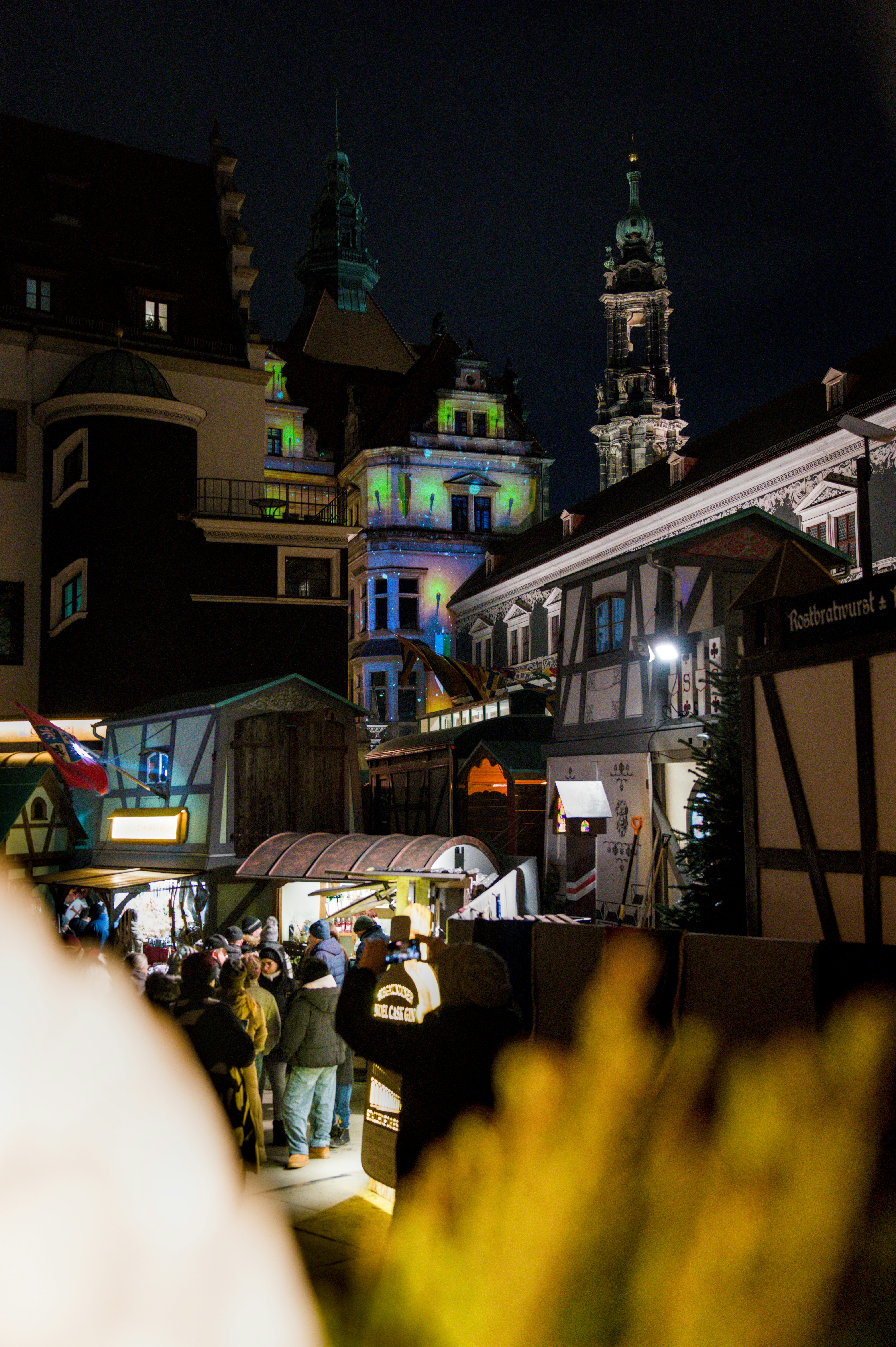 Night view of a european town square with illuminated buildings.