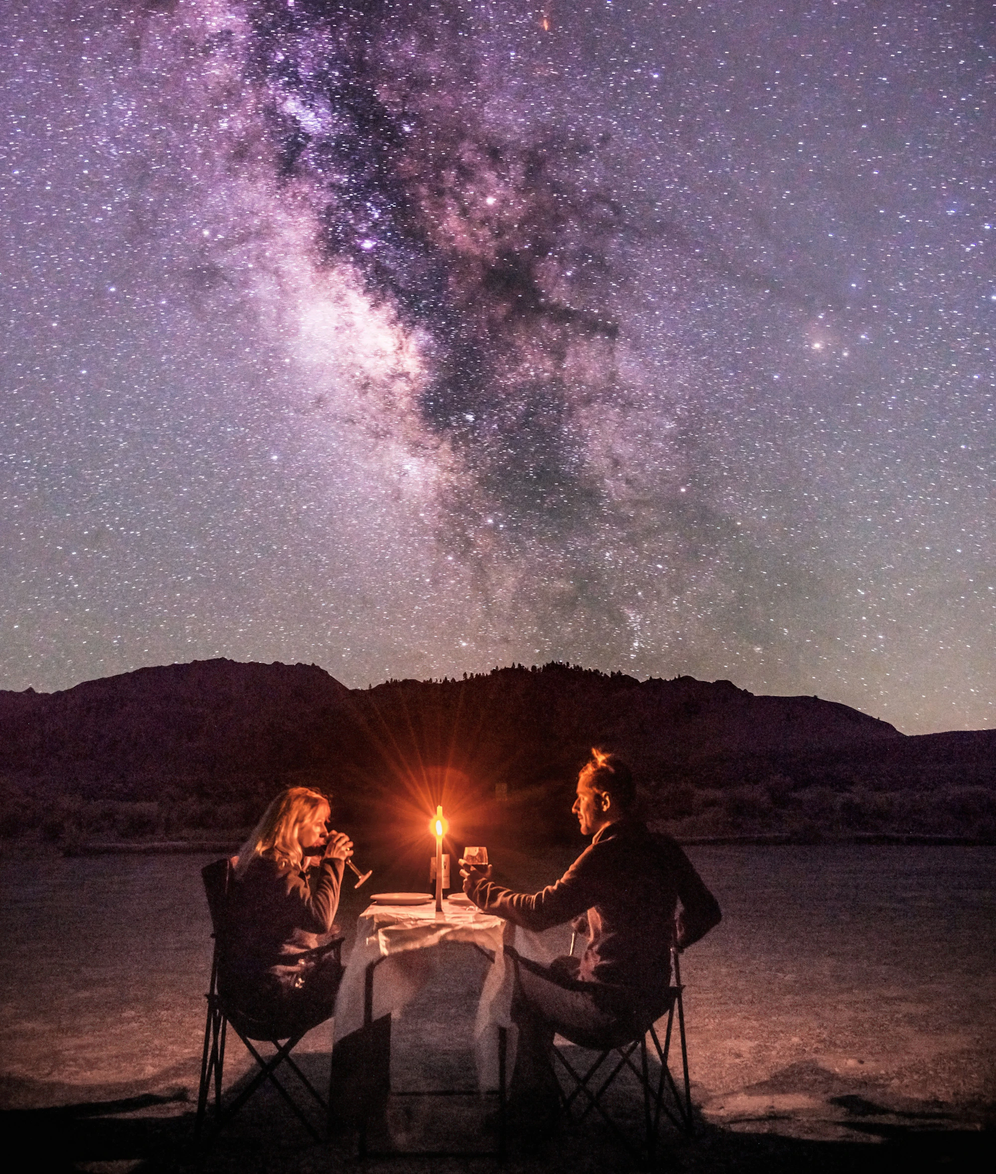 Couple stargazing under the Milky Way during a private stargazing Bali experience