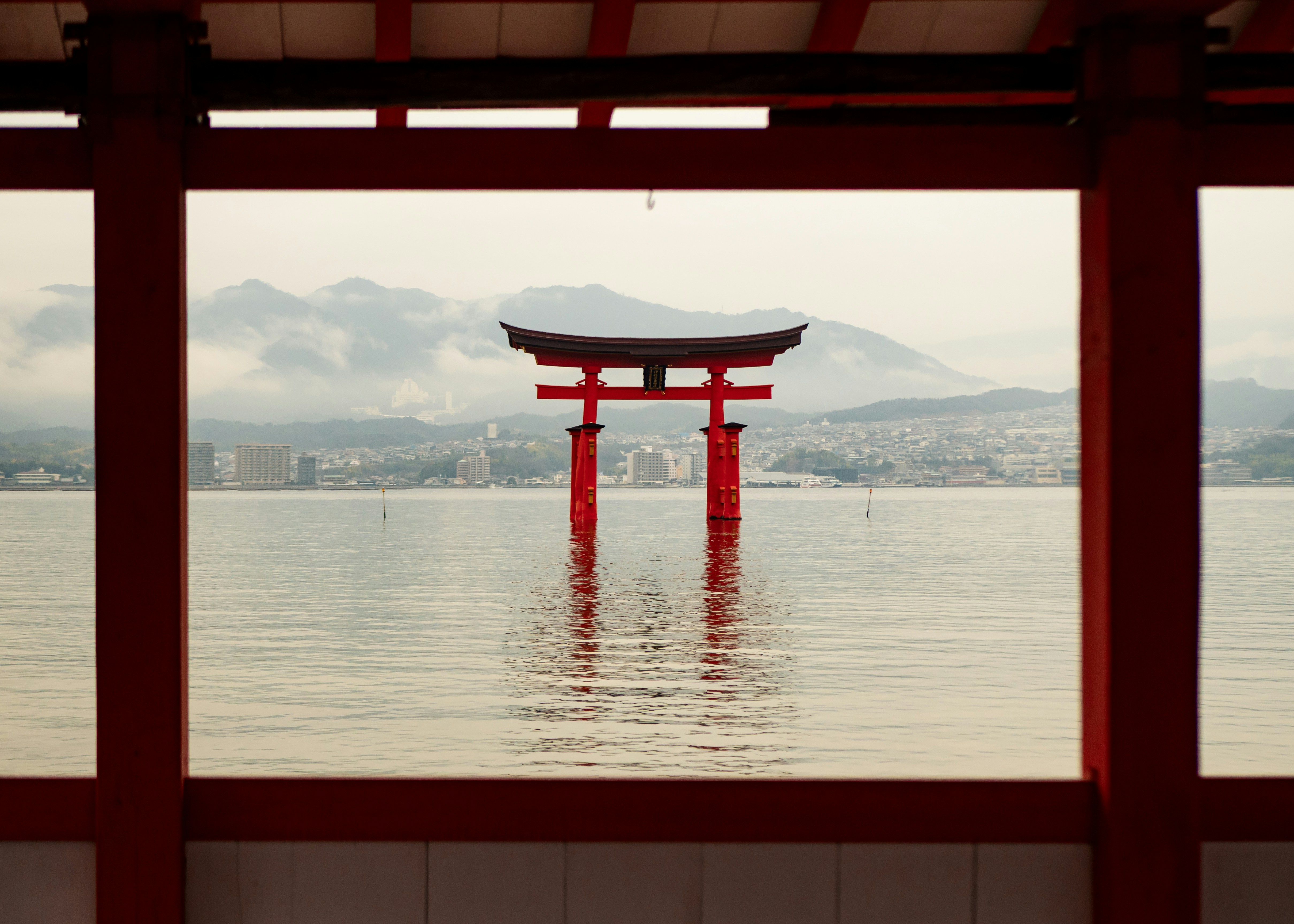Red torii gate in the water at sunset