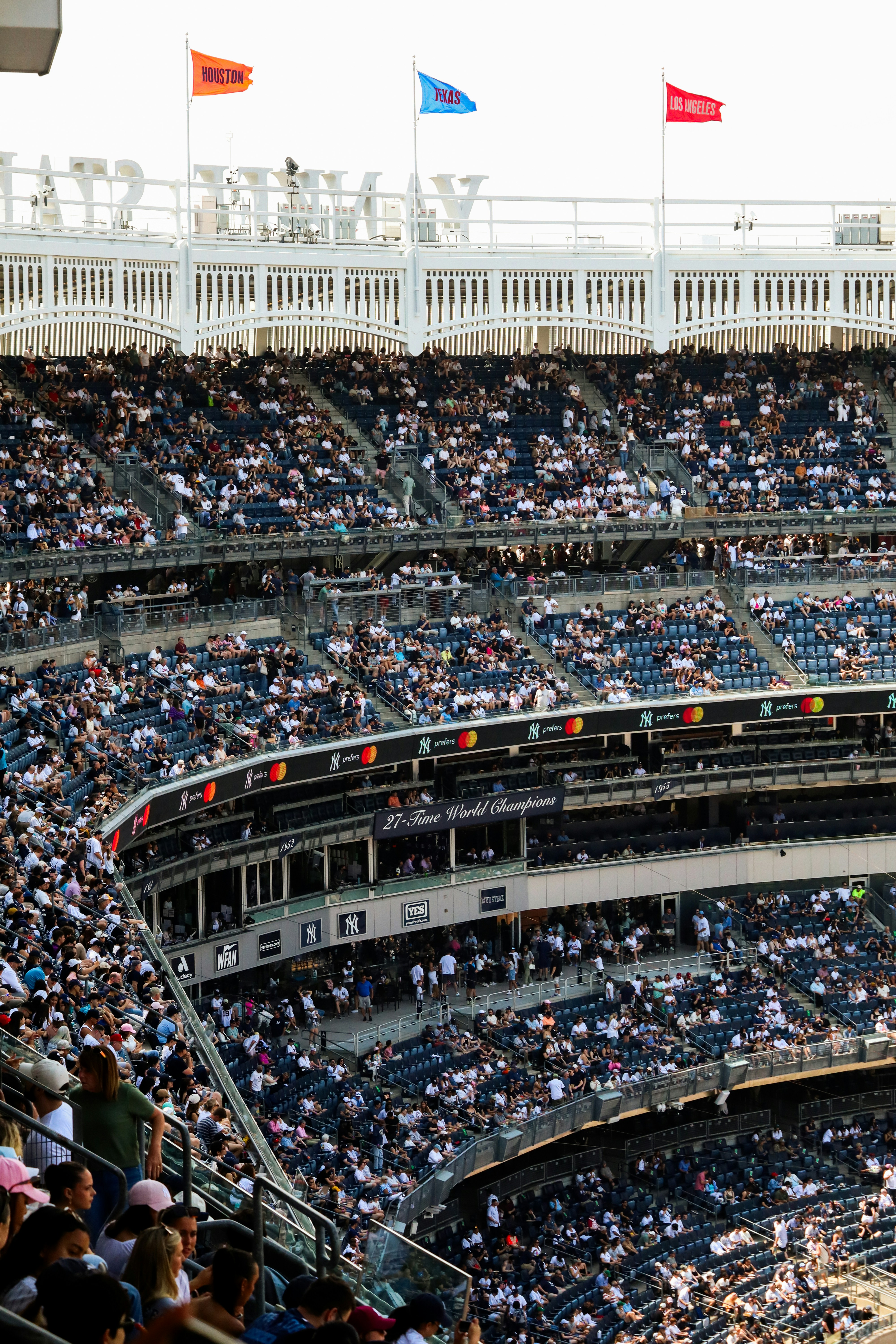 Crowded stadium stands with flags at the top