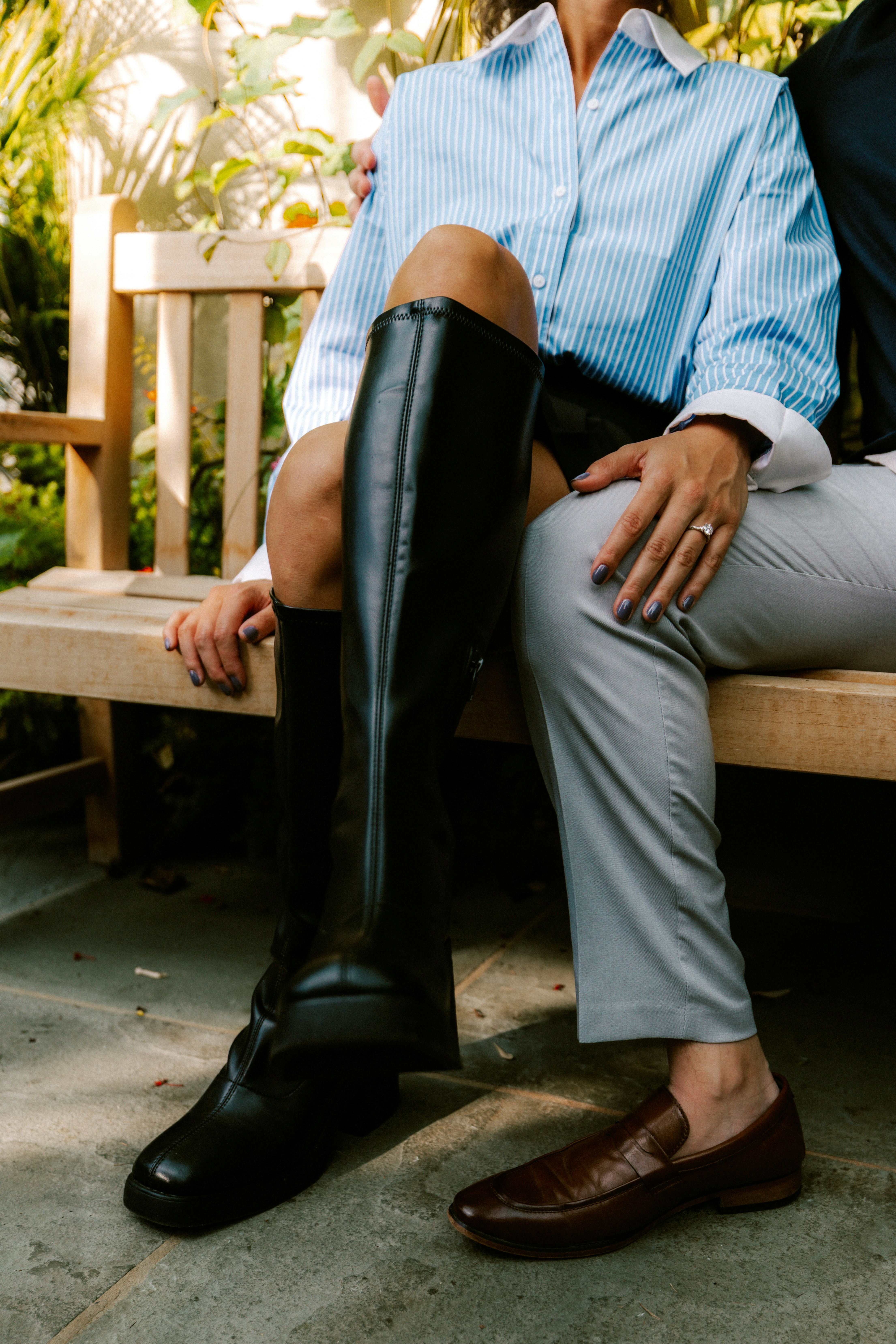 Woman in boots and man in loafers sitting