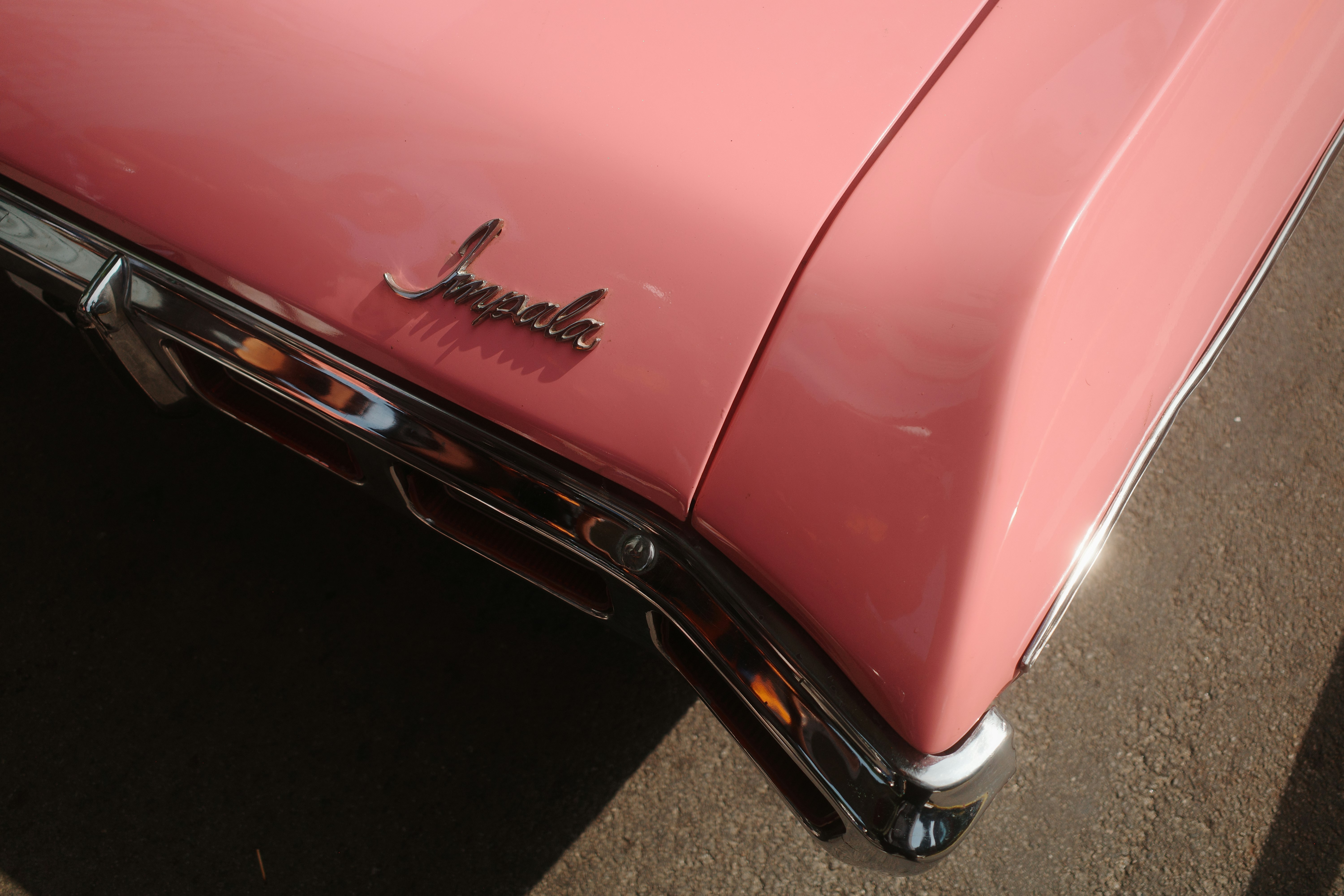 Close-up of a pink vintage car's fender