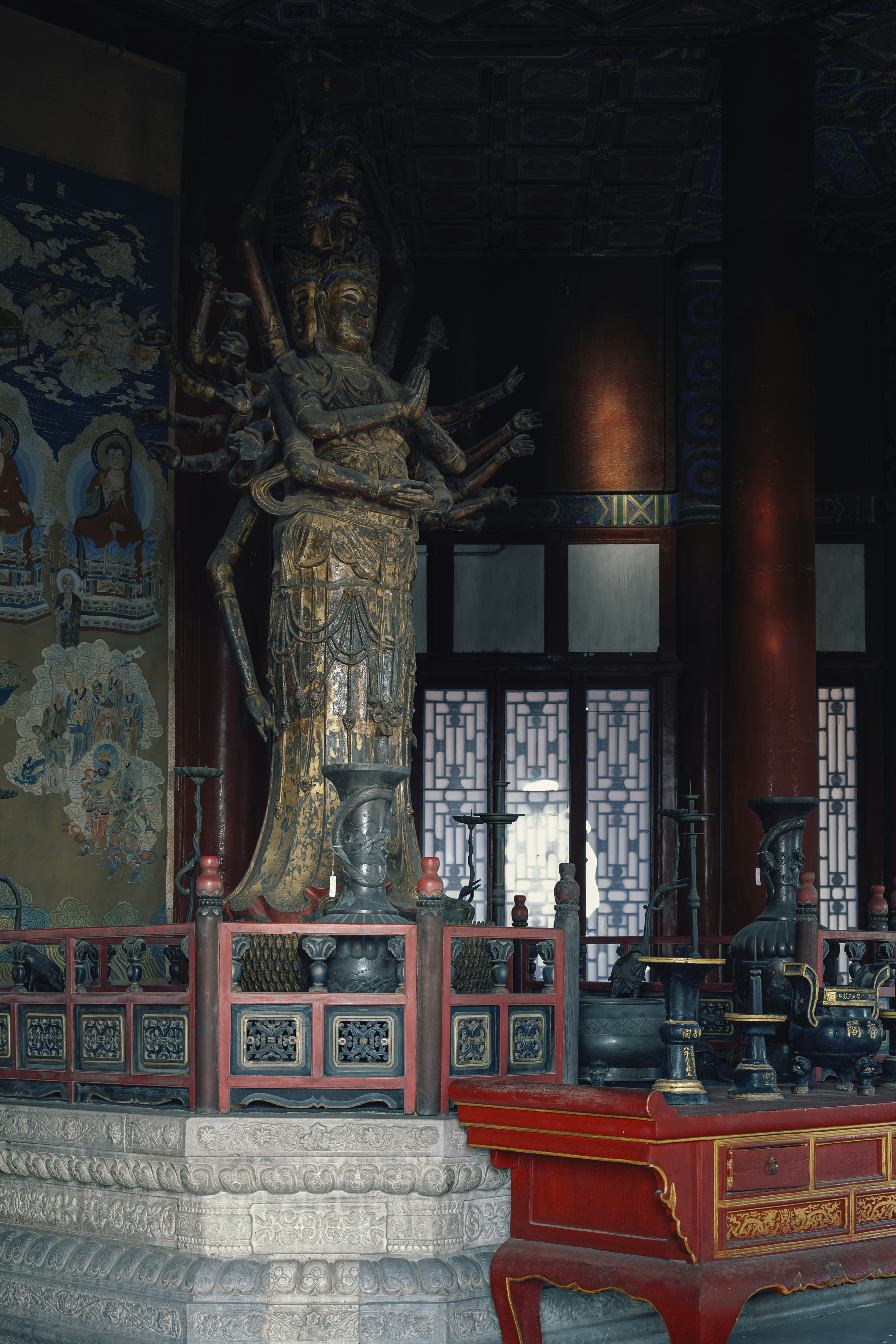 Golden multi-armed statue inside a temple