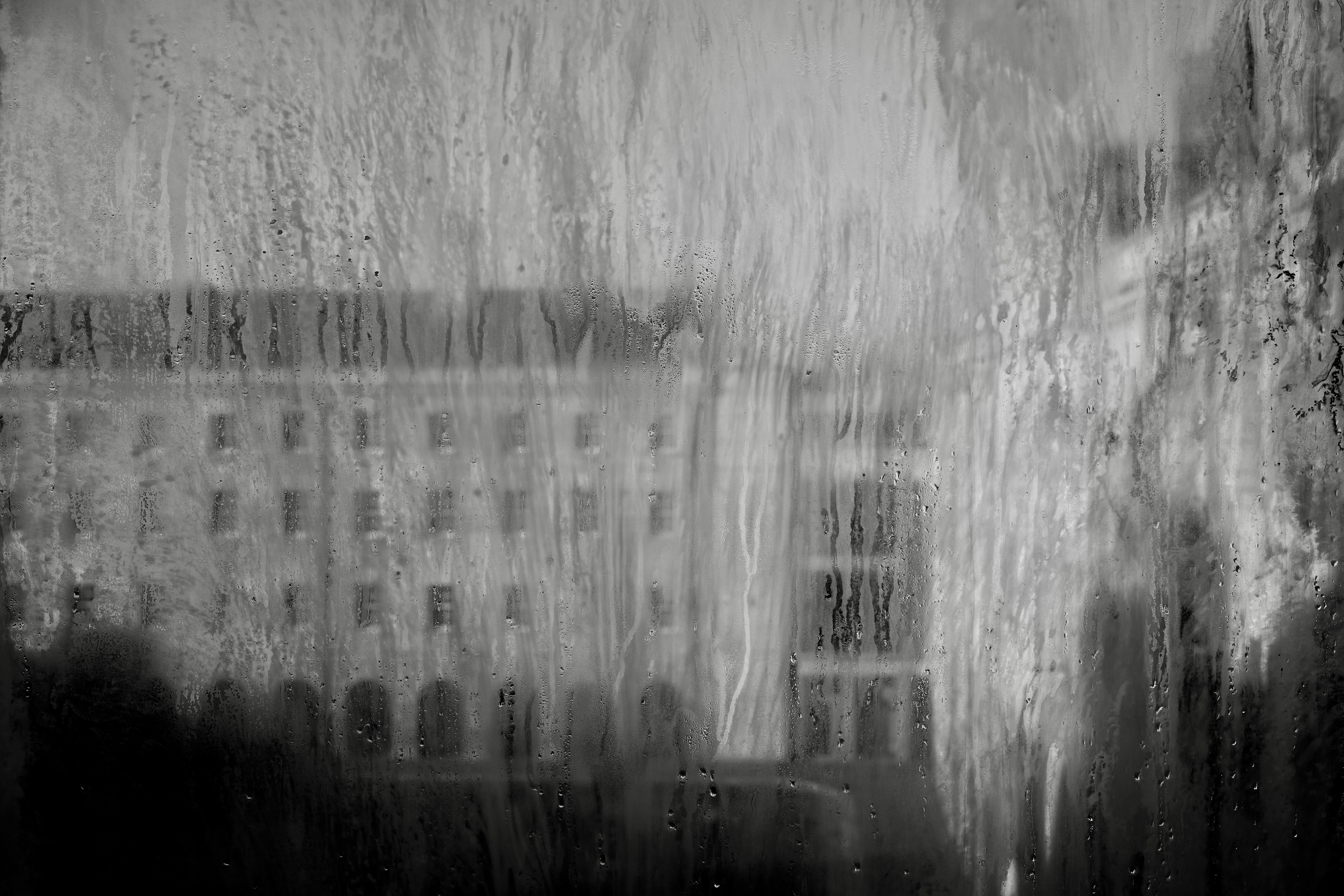 Blurred building seen through a wet window pane