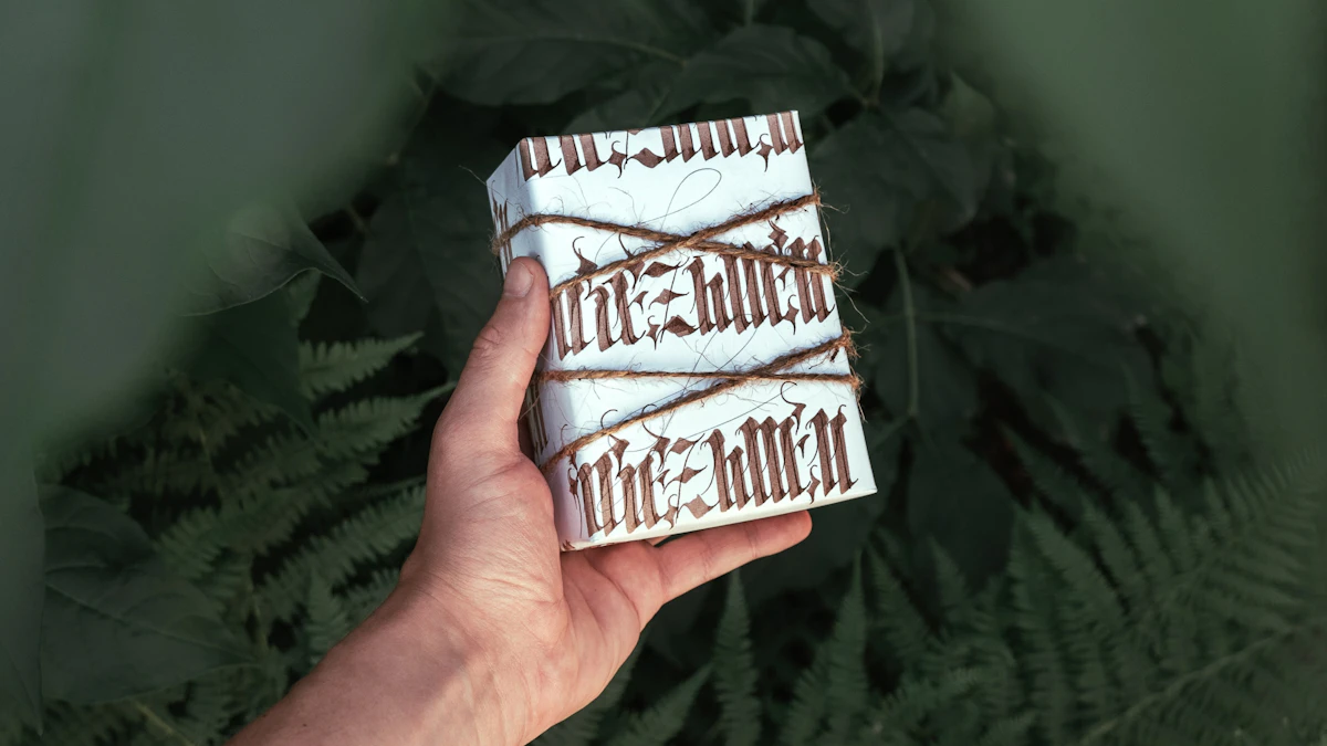 Hand holding a wrapped gift box with twine