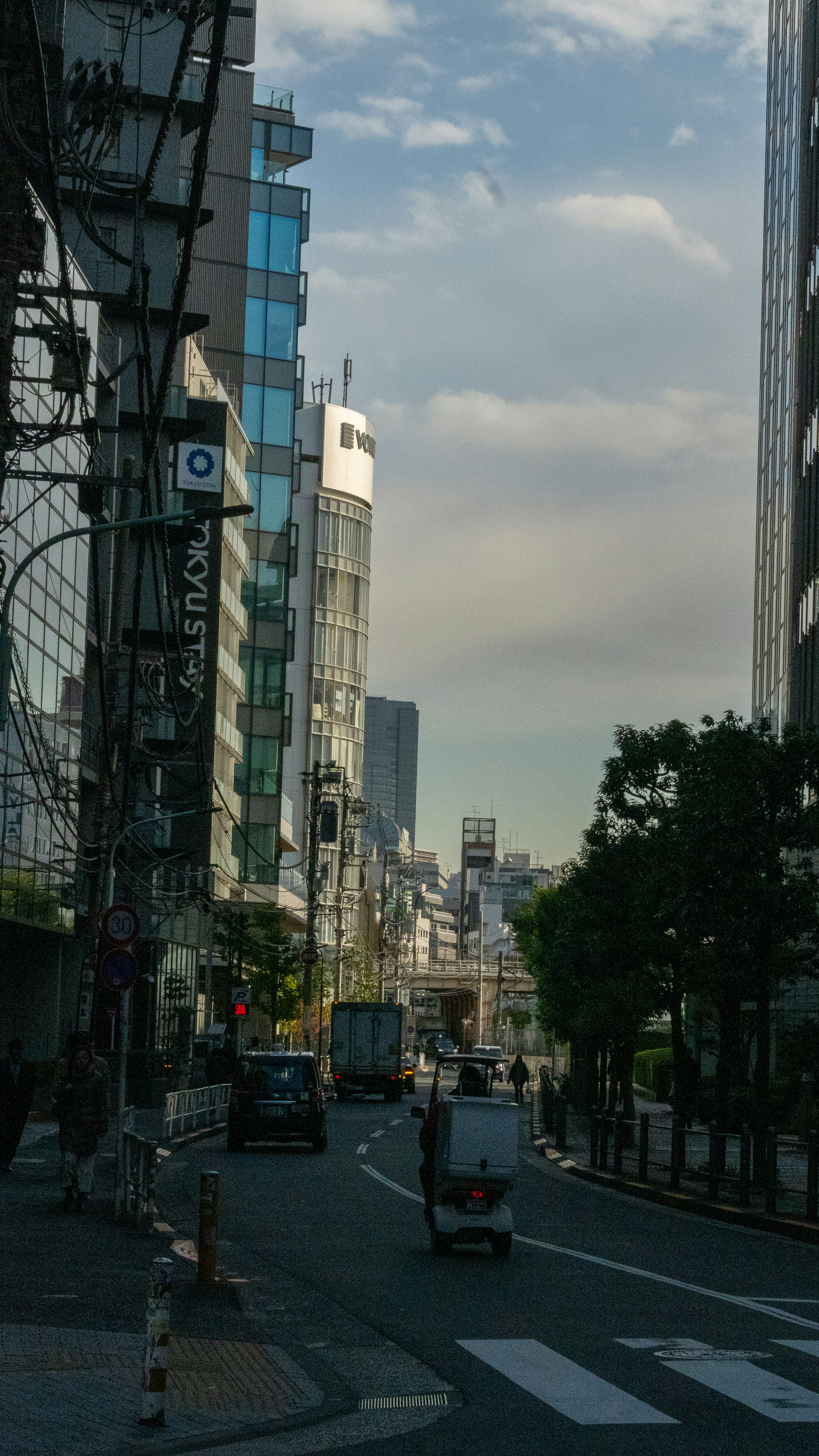 Straßenansicht einer Stadt mit Gebäuden und Fahrzeugen.