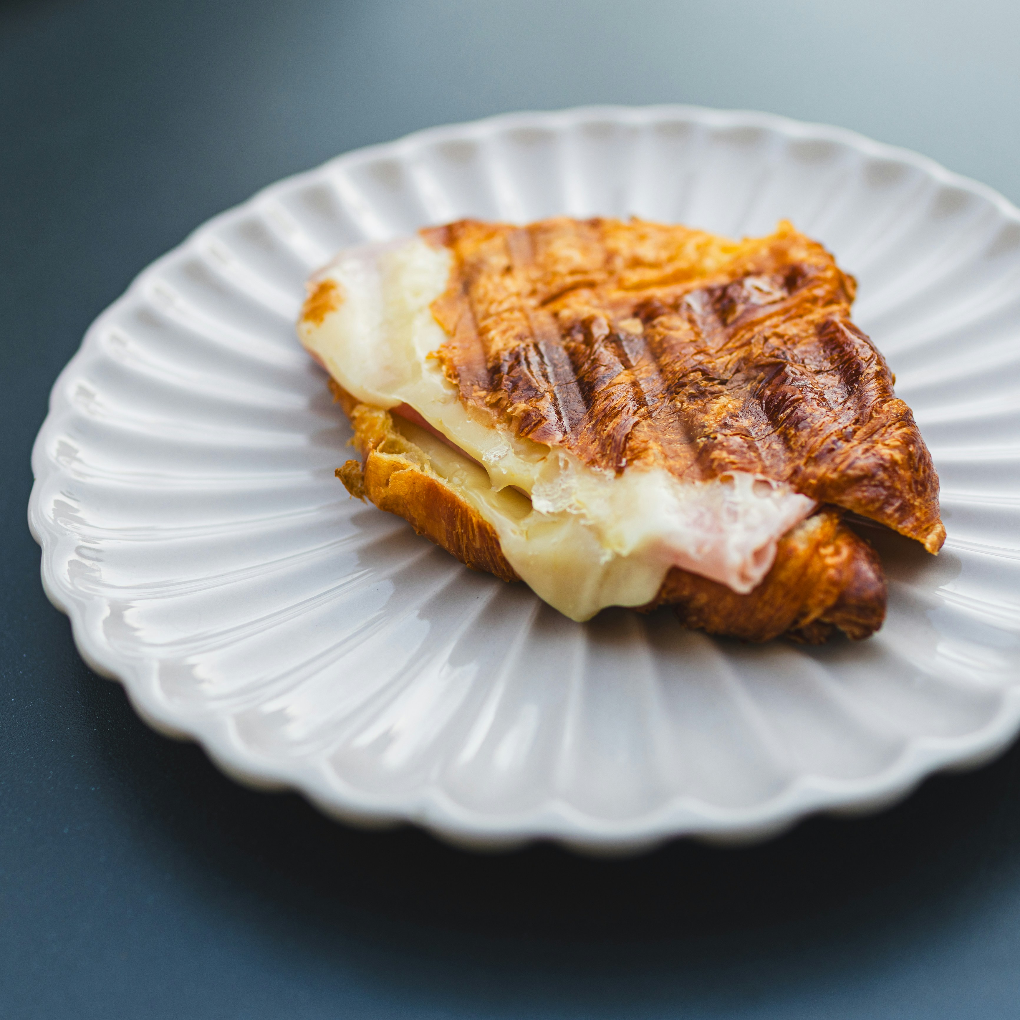 Croissant sandwich with melted cheese and ham