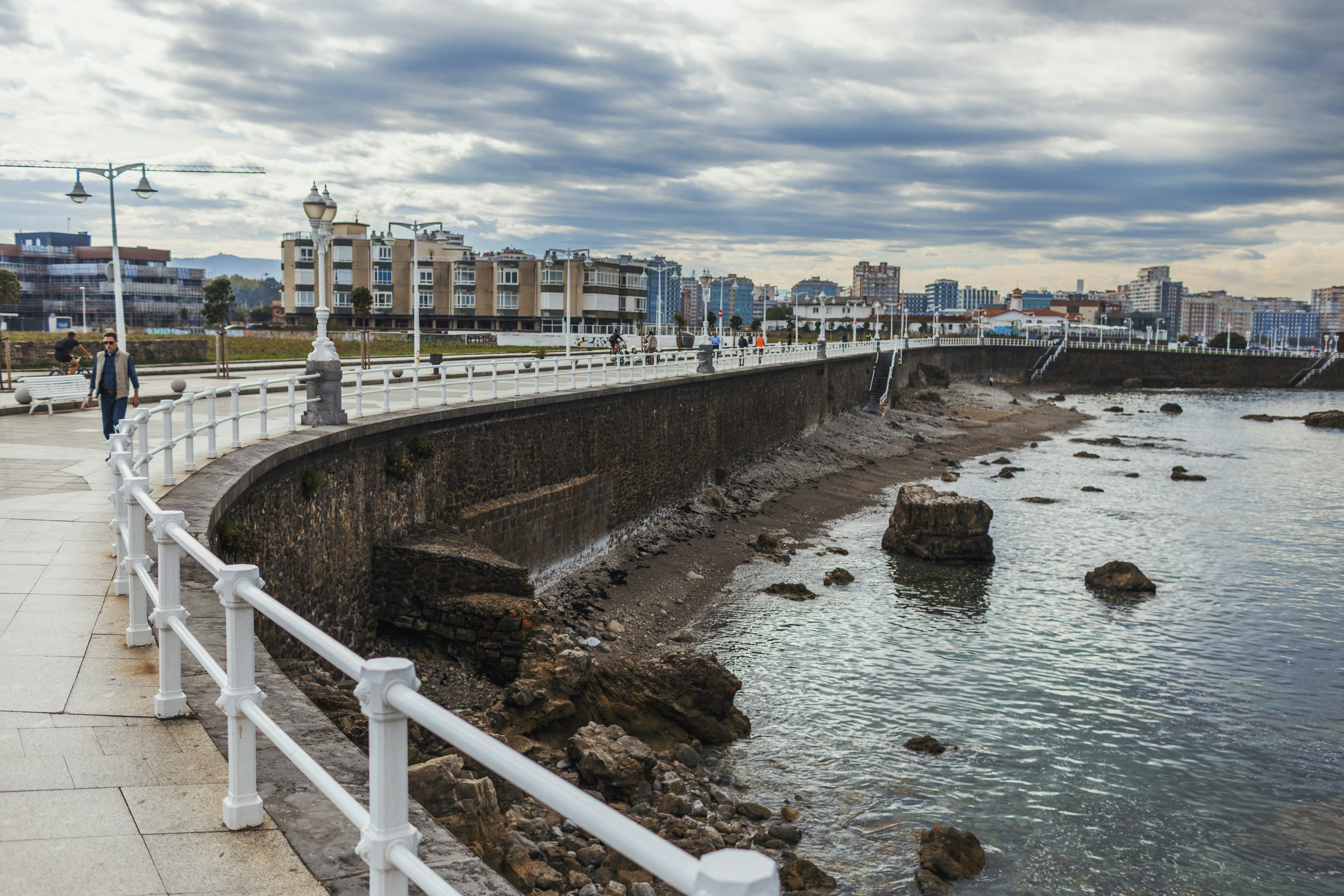 Seaside promenade with city buildings in background - Gijón