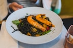 Black pasta with shrimp and basil on a plate
