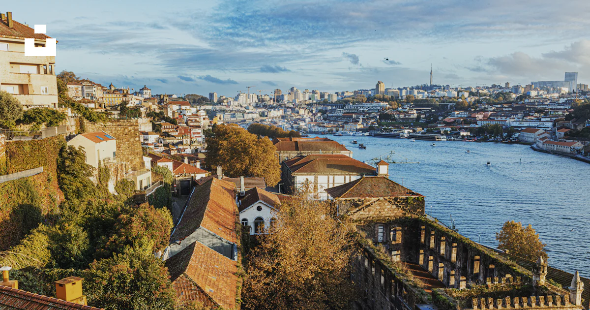 Unsplash Image Riverside Riverside city with historic buildings and distant skyline. photo ...