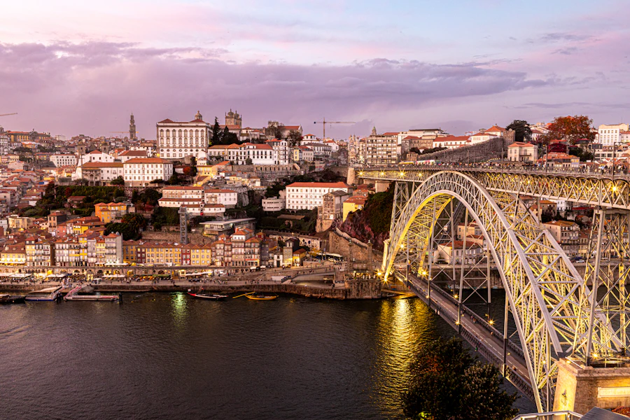 Dom Luís I Bridge and Ribeira hillside glowing at dusk over the Douro
