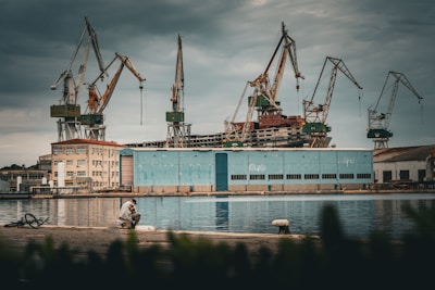 Industrial cranes over a building by the water