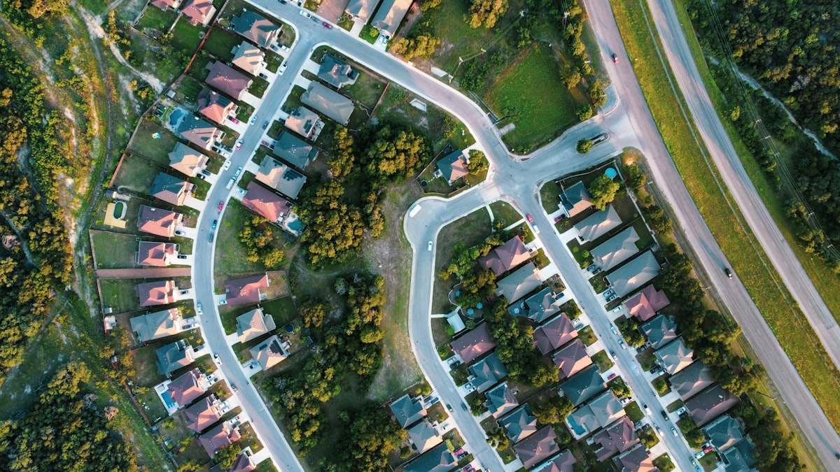 Aerial view of a suburban neighborhood with winding streets and houses